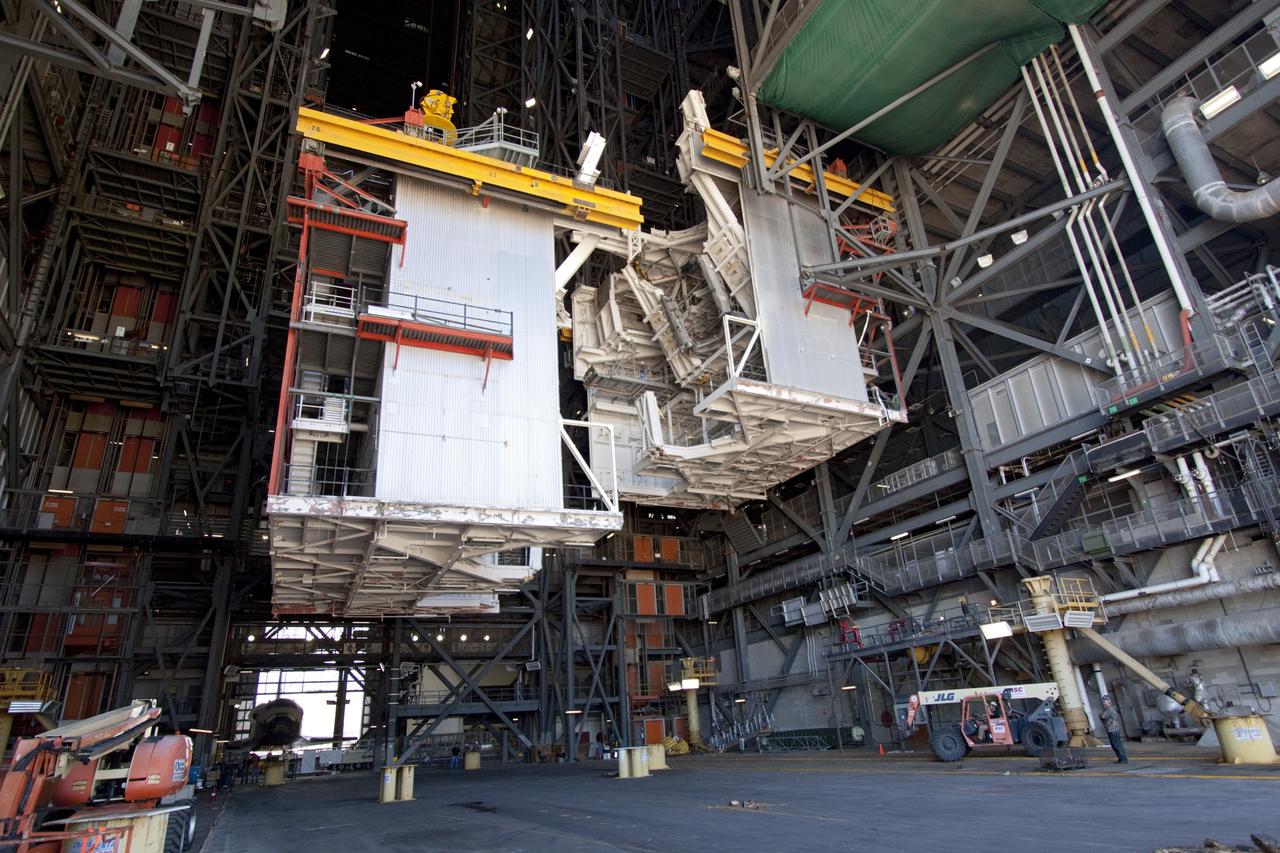 CAPE CANAVERAL, Fla. – As part of NASA's Ground Systems Development and Operations Program at the Kennedy Space Center in Florida, a large space shuttle-era work platform is being removed from high bay 3 of the Vehicle Assembly Building, or VAB. The work is part of a center-wide modernization and refurbishment initiative to accommodate NASA’s Space Launch System and a variety of other spacecraft instead of the whole building supporting one design. Visible in the lower-left background is the space shuttle Atlantis being readied for its move to the Kennedy Space Center Visitor Complex.       The Ground Systems Development and Operations Program is developing the necessary ground systems, infrastructure and operational approaches required to safely process, assemble, transport and launch the next generation of rockets and spacecraft in support of NASA’s exploration objectives. Future work also will replace the antiquated communications, power and vehicle access resources with modern efficient systems. Some of the utilities and systems slated for replacement have been used since the VAB opened in 1965. For more information, visit http://www.nasa.gov/exploration/systems/ground/index.html Photo credit: NASA/Jim Grossmann