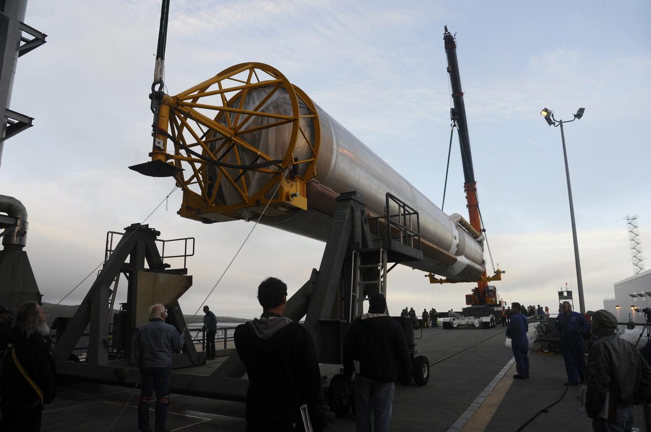 VANDENBERG AFB, Calif. – Cranes raise the first stage booster of a United Launch Alliance Atlas V onto the launch pad at Space Launch Complex-3E at Vandenberg Air Force Base, Calif. in preparation for the launch of the Landsat Data Continuity Mission. The Landsat Data Continuity Mission LDCM is the future of Landsat satellites. It will continue to obtain valuable data and imagery to be used in agriculture, education, business, science, and government. The Landsat Program provides repetitive acquisition of high resolution multispectral data of the Earth's surface on a global basis. The data from the Landsat spacecraft constitute the longest record of the Earth's continental surfaces as seen from space. It is a record unmatched in quality, detail, coverage, and value. Launch is planned for Feb. 2013. Photo credit: NASA/Roy Allison