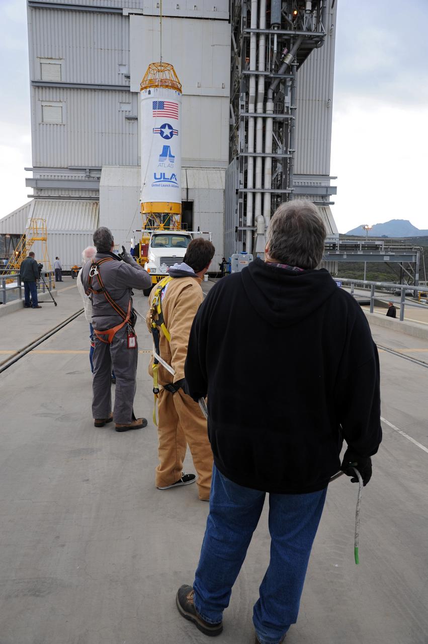 VANDENBERG AFB, Calif. – A Centaur upper stage is lifted onto the first stage booster of a United Launch Alliance Atlas V at the launch pad at Space Launch Complex-3E at Vandenberg Air Force Base, Calif. in preparation for the launch of the Landsat Data Continuation Mission.   The Landsat Data Continuity Mission LDCM is the future of Landsat satellites. It will continue to obtain valuable data and imagery to be used in agriculture, education, business, science, and government. The Landsat Program provides repetitive acquisition of high resolution multispectral data of the Earth's surface on a global basis. The data from the Landsat spacecraft constitute the longest record of the Earth's continental surfaces as seen from space. It is a record unmatched in quality, detail, coverage, and value. Launch is planned for Feb. 2013. Photo credit: NASA/Roy Allison