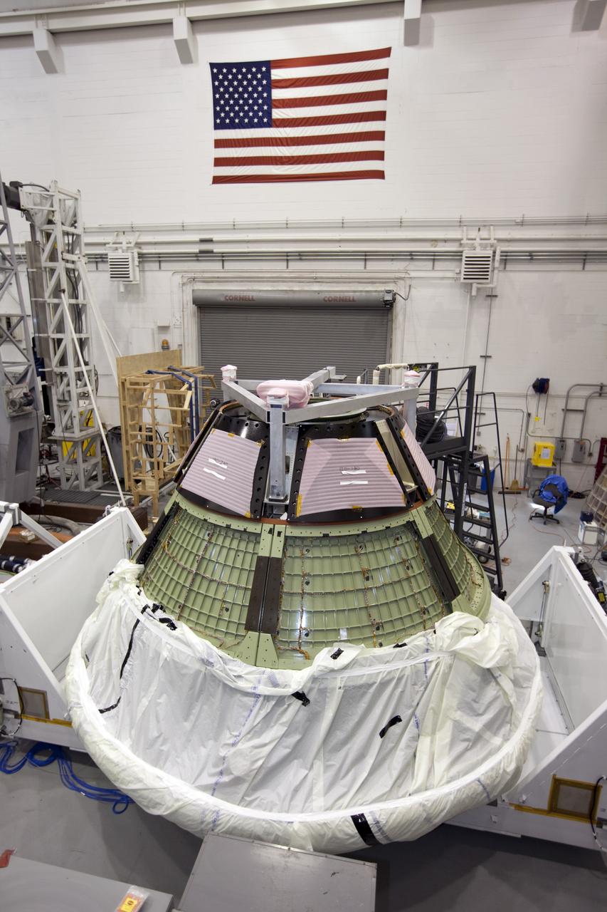 CAPE KENNEDY, Fla. -- Inside the Launch Equipment Test Facility at NASA’s Kennedy Space in Florida, the Orion ground test vehicle has been transferred to a test stand and prepared for a pyrotechnic bolt test.  Lockheed Martin performed tests over a series of days on the explosive bolts that separate Orion from the launch abort system. Data was collected on the effect of shock waves on Orion during the explosive bolt separation. Orion is the exploration spacecraft designed to carry crews to space beyond low Earth orbit. It will provide emergency abort capability, sustain the crew during the space travel and provide safe re-entry from deep space return velocities. The first unpiloted test flight of the Orion is scheduled to launch in 2014 atop a Delta IV rocket and in 2017 on a Space Launch System rocket. For more information, visit http://www.nasa.gov/orion. Photo credit: NASA/Kim Shiflett