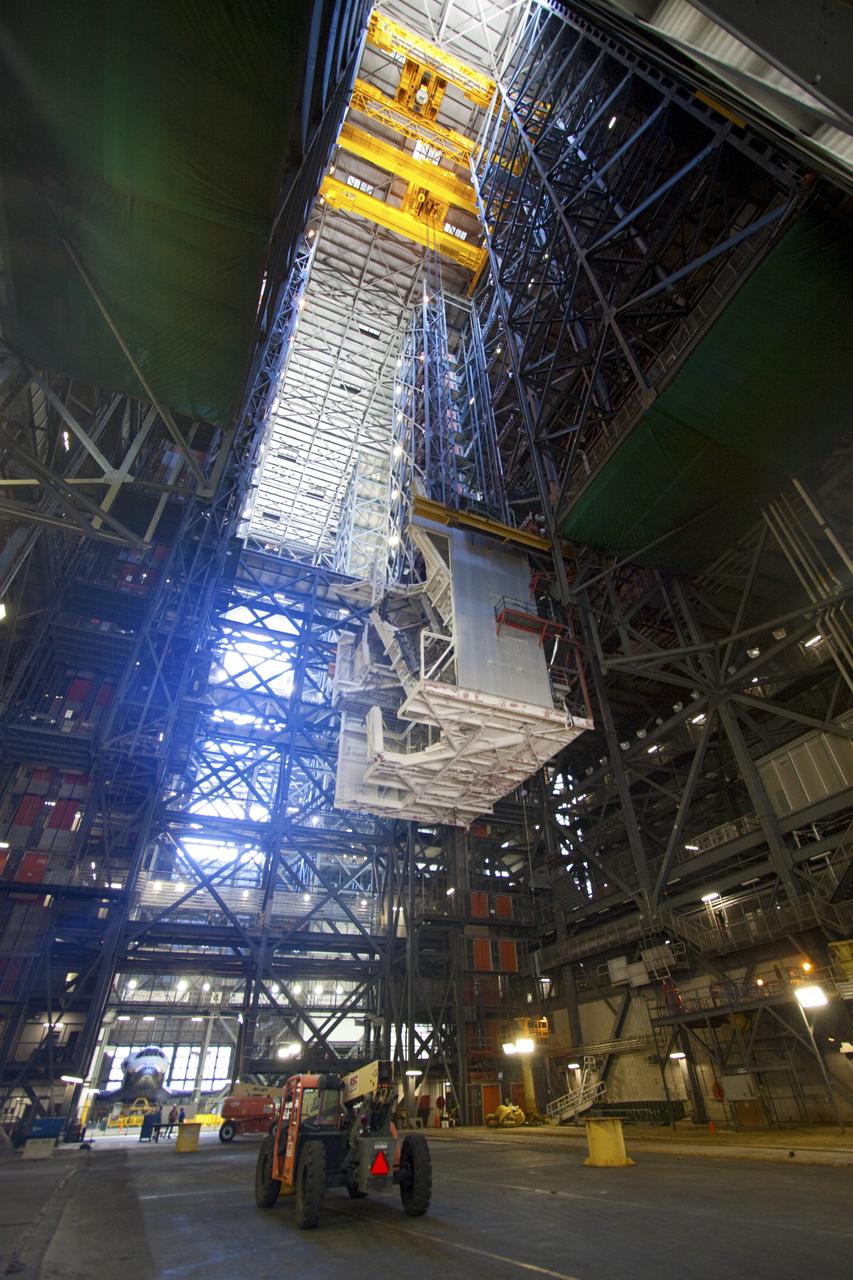 CAPE CANAVERAL, Fla. – As part of NASA's Ground Systems Development and Operations Program at the Kennedy Space Center in Florida, a large space shuttle-era work platform is being removed from high bay 3 of the Vehicle Assembly Building, or VAB. The work is part of a center-wide modernization and refurbishment initiative to accommodate NASA’s Space Launch System and a variety of other spacecraft instead of the whole building supporting one design. Visible in the background on the lower left is the space shuttle Atlantis being readied for its move to the Kennedy Space Center Visitor Complex.      The Ground Systems Development and Operations Program is developing the necessary ground systems, infrastructure and operational approaches required to safely process, assemble, transport and launch the next generation of rockets and spacecraft in support of NASA’s exploration objectives. Future work also will replace the antiquated communications, power and vehicle access resources with modern efficient systems. Some of the utilities and systems slated for replacement have been used since the VAB opened in 1965. For more information, visit http://www.nasa.gov/exploration/systems/ground/index.html Photo credit: NASA/Jim Grossmann