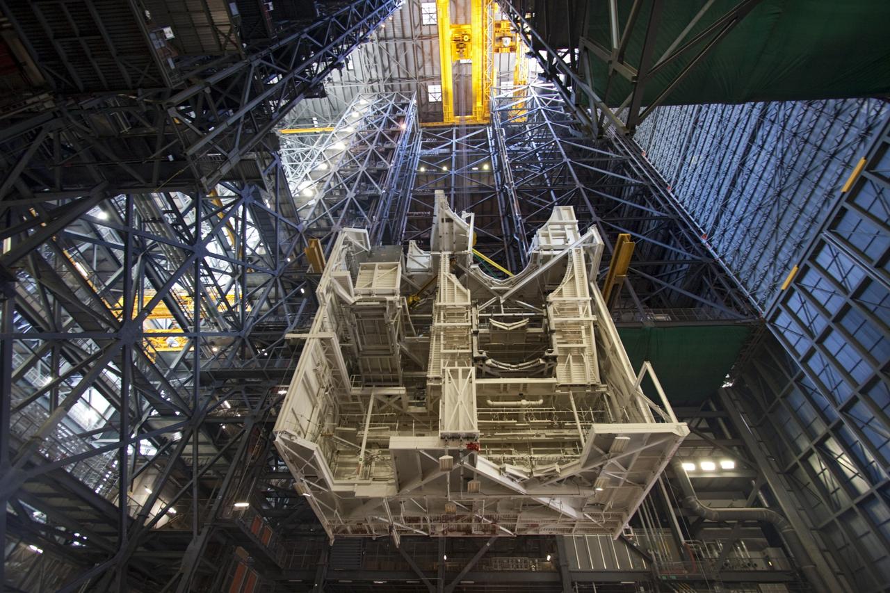CAPE CANAVERAL, Fla. – As part of NASA's Ground Systems Development and Operations Program at the Kennedy Space Center in Florida, a large space shuttle-era work platform is being lowered and removed from high bay 3 of the Vehicle Assembly Building, or VAB. The work is part of a center-wide modernization and refurbishment initiative to accommodate NASA’s Space Launch System and a variety of other spacecraft instead of the whole building supporting one design. The Ground Systems Development and Operations Program is developing the necessary ground systems, infrastructure and operational approaches required to safely process, assemble, transport and launch the next generation of rockets and spacecraft in support of NASA’s exploration objectives. Future work also will replace the antiquated communications, power and vehicle access resources with modern efficient systems. Some of the utilities and systems slated for replacement have been used since the VAB opened in 1965. For more information, visit http://www.nasa.gov/exploration/systems/ground/index.html Photo credit: NASA/Jim Grossmann