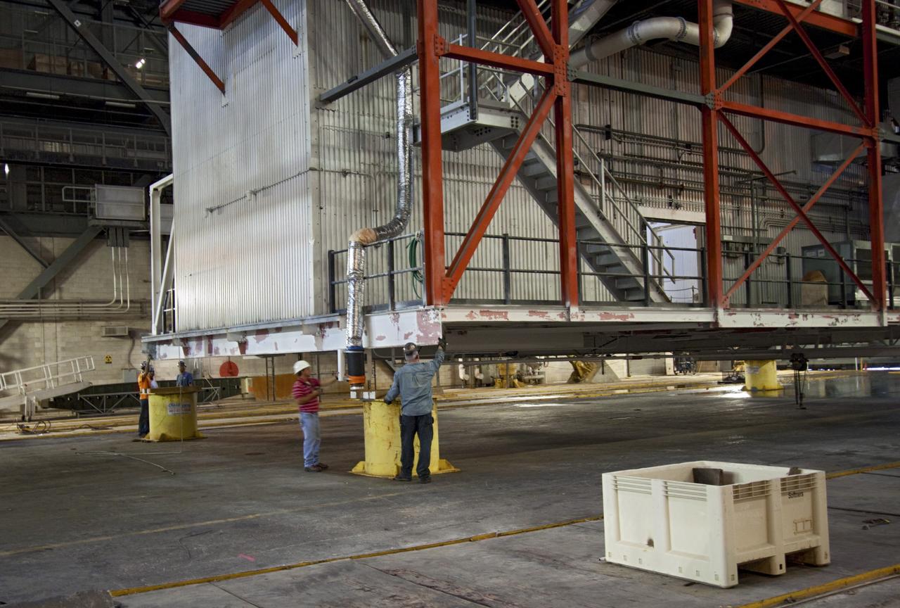 CAPE CANAVERAL, Fla. – As part of NASA's Ground Systems Development and Operations Program at the Kennedy Space Center in Florida, a large space shuttle-era work platform is being positioned on pedestals for removal from high bay 3 of the Vehicle Assembly Building, or VAB. The work is part of a center-wide modernization and refurbishment initiative to accommodate NASA’s Space Launch System and a variety of other spacecraft instead of the whole building supporting one design. The Ground Systems Development and Operations Program is developing the necessary ground systems, infrastructure and operational approaches required to safely process, assemble, transport and launch the next generation of rockets and spacecraft in support of NASA’s exploration objectives. Future work also will replace the antiquated communications, power and vehicle access resources with modern efficient systems. Some of the utilities and systems slated for replacement have been used since the VAB opened in 1965. For more information, visit http://www.nasa.gov/exploration/systems/ground/index.html Photo credit: NASA/Jim Grossmann