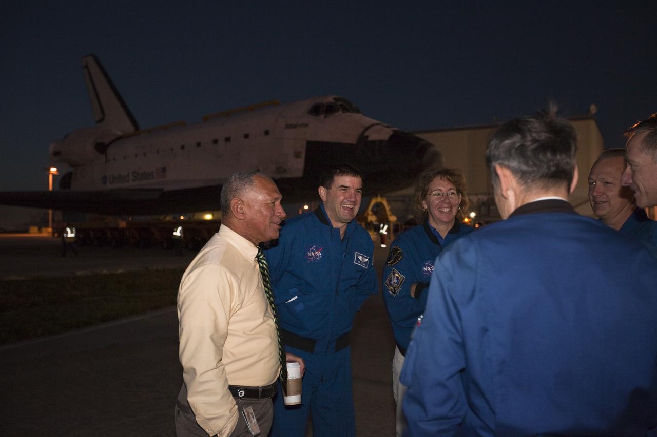 CAPE CANAVERAL, Fla. – NASA Administrator Charles Bolden, far left, talks with STS-135 crew members Rex Walheim, Sandy Magnus, Doug Hurley and Chris Ferguson, along with Kennedy Space Center Director Bob Cabana back to camera as the space shuttle Atlantis moves out of the Vehicle Assembly Building at Kennedy for its 10-mile trip to the Kennedy Visitor Complex where it will be put on public display. As part of transition and retirement of the Space Shuttle Program, Atlantis is to be displayed at Kennedy's Visitor Complex beginning in the summer of 2013. Over the course of its 26-year career, Atlantis traveled 125,935,769 miles during 307 days in space over 33 missions. For more information, visit http://www.nasa.gov/transition Photo credit: NASA/ Kim Shiflett