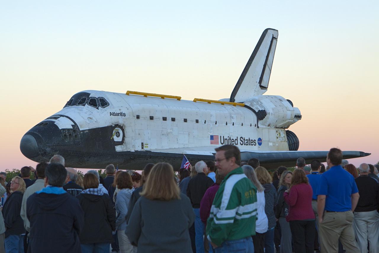 CAPE CANAVERAL, Fla. – Space shuttle workers at NASA's Kennedy Space Center in Florida, watch as the space shuttle Atlantis is transported on a 10-mile journey to the Kennedy Visitor Complex where it will be put on public display. As part of transition and retirement of the Space Shuttle Program, Atlantis is to be displayed at Kennedy's Visitor Complex beginning in the summer of 2013. Over the course of its 26-year career, Atlantis traveled 125,935,769 miles during 307 days in space over 33 missions. For more information, visit http://www.nasa.gov/transition Photo credit: NASA/ Kim Shiflett
