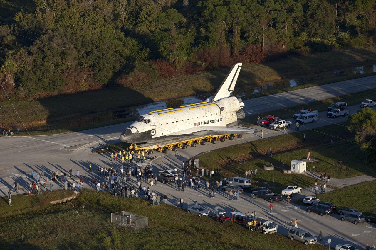 CAPE CANAVERAL, Fla. – Space shuttle Atlantis is transported along Kennedy Parkway at NASA's Kennedy Space Center in Florida on its 10-mile journey to the Kennedy Visitor Complex where it will be put on public display. As part of transition and retirement of the Space Shuttle Program, Atlantis is to be displayed at Kennedy's Visitor Complex beginning in the summer of 2013. Over the course of its 26-year career, Atlantis traveled 125,935,769 miles during 307 days in space over 33 missions. For more information, visit http://www.nasa.gov/transition Photo credit: NASA/ Kim Shiflett