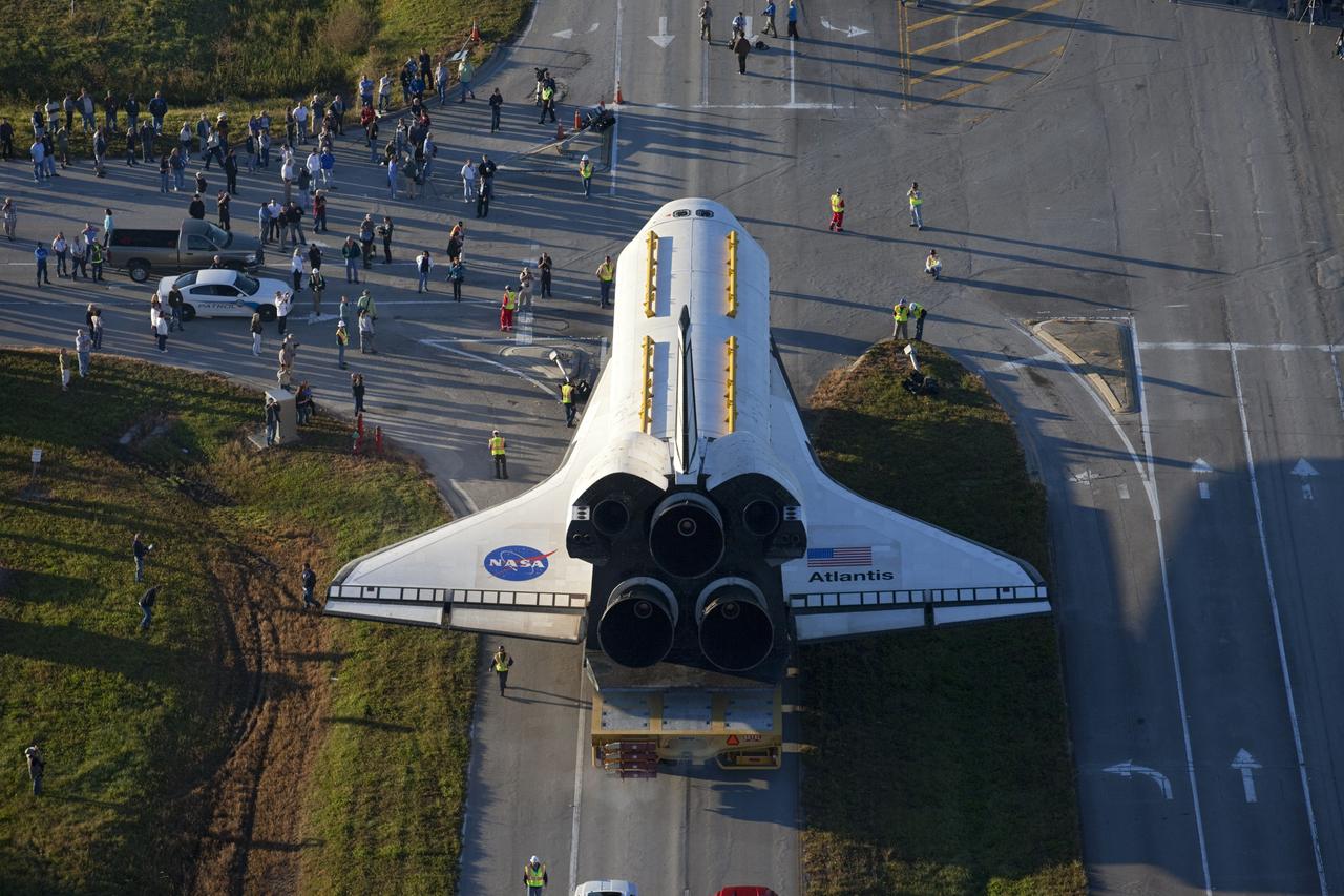 CAPE CANAVERAL, Fla. – Space shuttle Atlantis is transported along Kennedy Parkway at NASA's Kennedy Space Center in Florida on its 10-mile journey to the Kennedy Visitor Complex where it will be put on public display. As part of transition and retirement of the Space Shuttle Program, Atlantis is to be displayed at Kennedy's Visitor Complex beginning in the summer of 2013. Over the course of its 26-year career, Atlantis traveled 125,935,769 miles during 307 days in space over 33 missions. For more information, visit http://www.nasa.gov/transition Photo credit: NASA/ Kim Shiflett