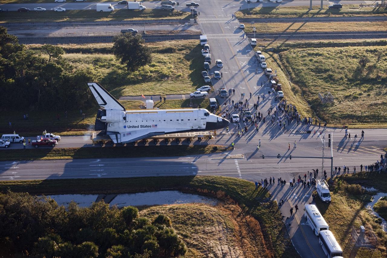 CAPE CANAVERAL, Fla. – Space shuttle Atlantis is transported along Kennedy Parkway at NASA's Kennedy Space Center in Florida on its 10-mile journey to the Kennedy Visitor Complex where it will be put on public display. As part of transition and retirement of the Space Shuttle Program, Atlantis is to be displayed at Kennedy's Visitor Complex beginning in the summer of 2013. Over the course of its 26-year career, Atlantis traveled 125,935,769 miles during 307 days in space over 33 missions. For more information, visit http://www.nasa.gov/transition Photo credit: NASA/ Kim Shiflett