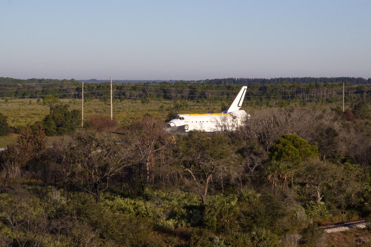 CAPE CANAVERAL, Fla. – Space shuttle Atlantis is transported along Kennedy Parkway at NASA's Kennedy Space Center in Florida on its 10-mile journey to the Kennedy Visitor Complex where it will be put on public display. As part of transition and retirement of the Space Shuttle Program, Atlantis is to be displayed at Kennedy's Visitor Complex beginning in the summer of 2013. Over the course of its 26-year career, Atlantis traveled 125,935,769 miles during 307 days in space over 33 missions. For more information, visit http://www.nasa.gov/transition Photo credit: NASA/ Kim Shiflett