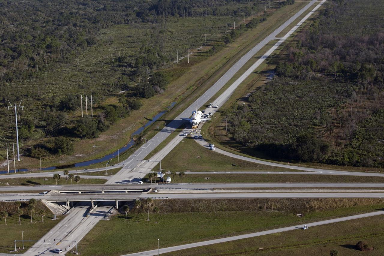 CAPE CANAVERAL, Fla. – Space shuttle Atlantis is transported along Kennedy Parkway at NASA's Kennedy Space Center in Florida on its 10-mile journey to the Kennedy Visitor Complex where it will be put on public display. As part of transition and retirement of the Space Shuttle Program, Atlantis is to be displayed at Kennedy's Visitor Complex beginning in the summer of 2013. Over the course of its 26-year career, Atlantis traveled 125,935,769 miles during 307 days in space over 33 missions. For more information, visit http://www.nasa.gov/transition Photo credit: NASA/ Kim Shiflett