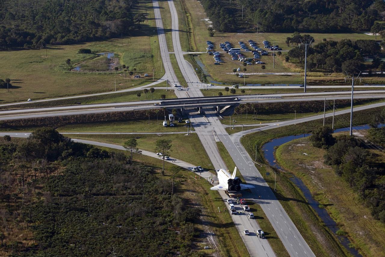 CAPE CANAVERAL, Fla. – Space shuttle Atlantis is transported along Kennedy Parkway at NASA's Kennedy Space Center in Florida on its 10-mile journey to the Kennedy Visitor Complex where it will be put on public display. As part of transition and retirement of the Space Shuttle Program, Atlantis is to be displayed at Kennedy's Visitor Complex beginning in the summer of 2013. Over the course of its 26-year career, Atlantis traveled 125,935,769 miles during 307 days in space over 33 missions. For more information, visit http://www.nasa.gov/transition Photo credit: NASA/ Kim Shiflett