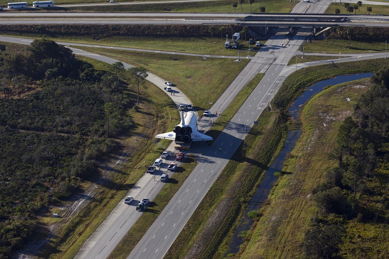CAPE CANAVERAL, Fla. – Space shuttle Atlantis is transported along Kennedy Parkway at NASA's Kennedy Space Center in Florida on its 10-mile journey to the Kennedy Visitor Complex where it will be put on public display. As part of transition and retirement of the Space Shuttle Program, Atlantis is to be displayed at Kennedy's Visitor Complex beginning in the summer of 2013. Over the course of its 26-year career, Atlantis traveled 125,935,769 miles during 307 days in space over 33 missions. For more information, visit http://www.nasa.gov/transition Photo credit: NASA/ Kim Shiflett