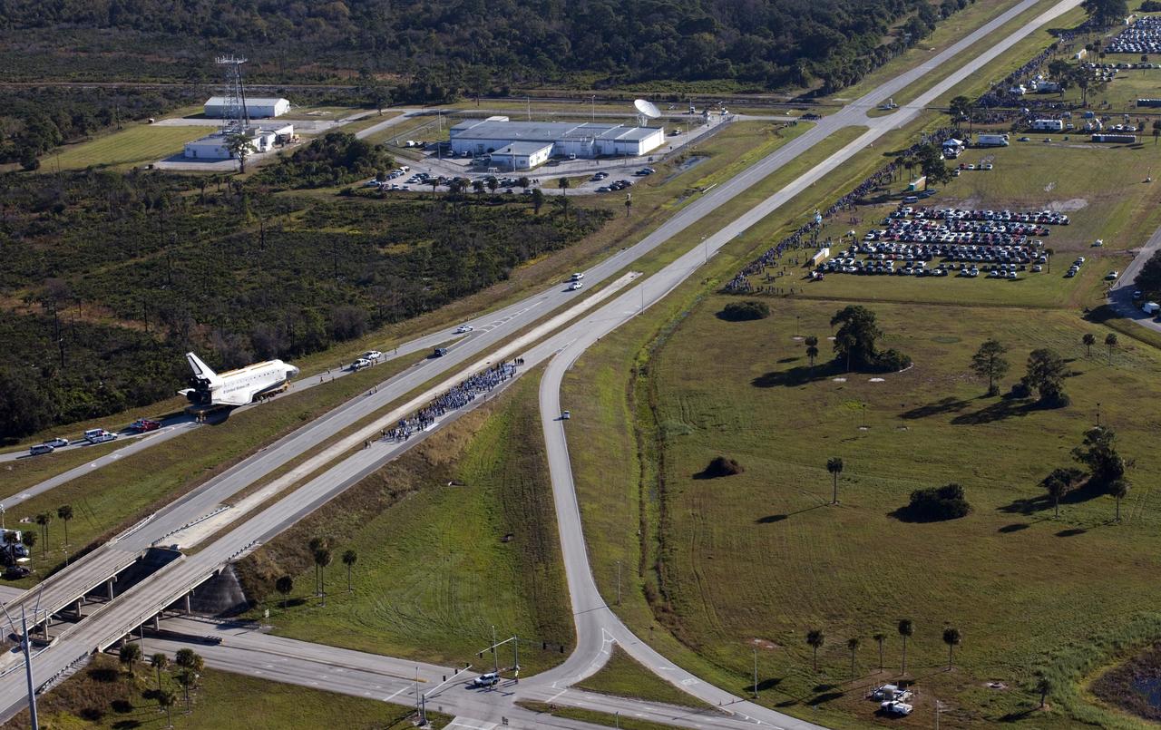 CAPE CANAVERAL, Fla. – Space shuttle Atlantis approaches NASA Causeway at NASA's Kennedy Space Center in Florida as it is transported on its 10-mile journey to the Kennedy Space Center Visitor Complex where it will be put on public display. As part of transition and retirement of the Space Shuttle Program, Atlantis is to be displayed at Kennedy's Visitor Complex beginning in the summer of 2013. Over the course of its 26-year career, Atlantis traveled 125,935,769 miles during 307 days in space over 33 missions. For more information, visit http://www.nasa.gov/transition Photo credit: NASA/ Kim Shiflett