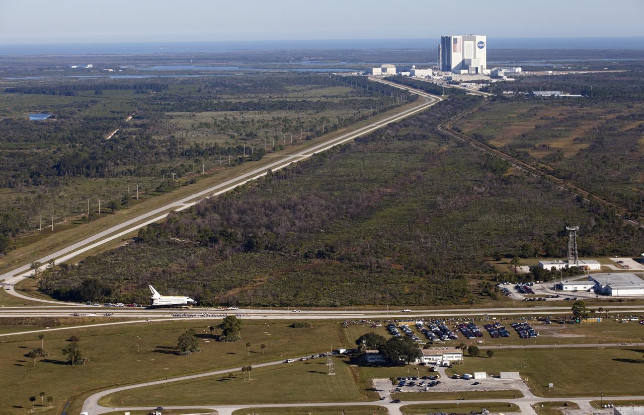 CAPE CANAVERAL, Fla. – Space shuttle Atlantis is transported along NASA Causeway at NASA's Kennedy Space Center in Florida on its 10-mile journey to the Kennedy Space Center Visitor Complex where it will be put on public display. As part of transition and retirement of the Space Shuttle Program, Atlantis is to be displayed at Kennedy's Visitor Complex beginning in the summer of 2013. Over the course of its 26-year career, Atlantis traveled 125,935,769 miles during 307 days in space over 33 missions. For more information, visit http://www.nasa.gov/transition Photo credit: NASA/ Kim Shiflett