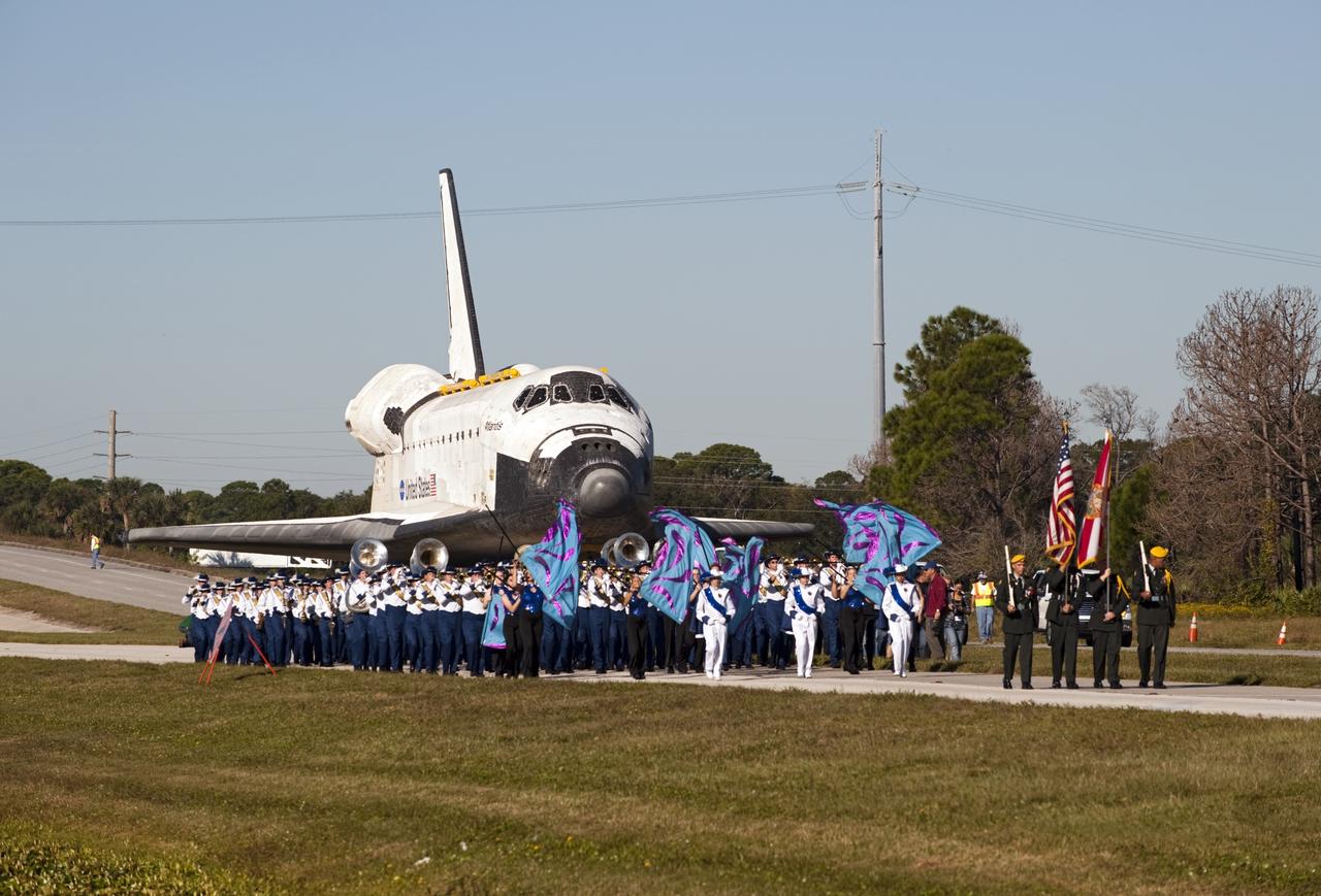 CAPE CANAVERAL, Fla. – Led by the Merritt Island High School color guard and the Titusville High School band, the space shuttle Atlantis is transported along NASA Causeway at NASA's Kennedy Space Center in Florida on its 10-mile journey to the Kennedy Space Center Visitor Complex where it will be put on public display. As part of transition and retirement of the Space Shuttle Program, Atlantis is to be displayed at Kennedy's Visitor Complex beginning in the summer of 2013. Over the course of its 26-year career, Atlantis traveled 125,935,769 miles during 307 days in space over 33 missions. For more information, visit http://www.nasa.gov/transition Photo credit: NASA/ Tony Gray