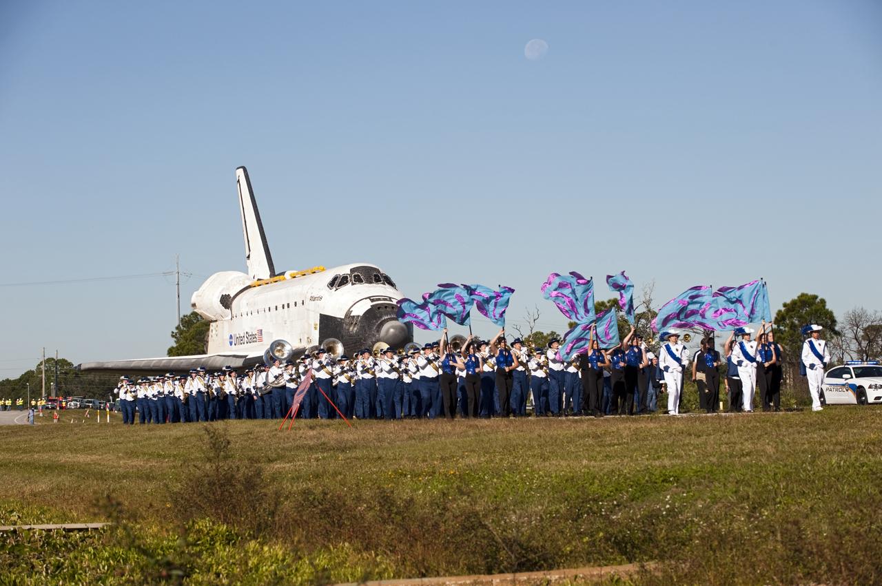 CAPE CANAVERAL, Fla. – Led by the Titusville High School band, the space shuttle Atlantis is transported along NASA Causeway at NASA's Kennedy Space Center in Florida on its 10-mile journey to the Kennedy Space Center Visitor Complex where it will be put on public display. As part of transition and retirement of the Space Shuttle Program, Atlantis is to be displayed at Kennedy's Visitor Complex beginning in the summer of 2013. Over the course of its 26-year career, Atlantis traveled 125,935,769 miles during 307 days in space over 33 missions. For more information, visit http://www.nasa.gov/transition Photo credit: NASA/ Tony Gray