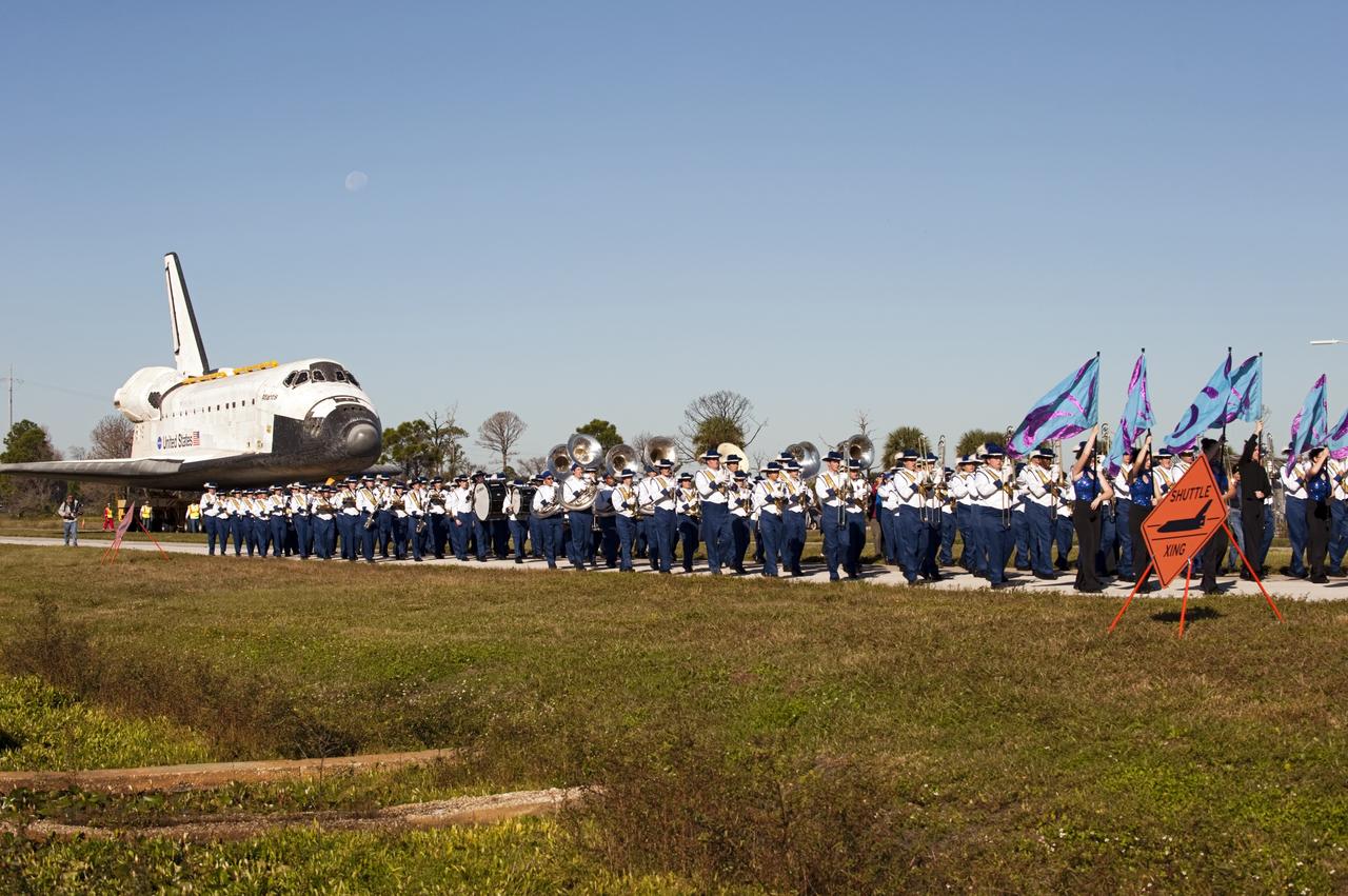 CAPE CANAVERAL, Fla. – Led by the Titusville High School band, the space shuttle Atlantis is transported along NASA Causeway at NASA's Kennedy Space Center in Florida on its 10-mile journey to the Kennedy Space Center Visitor Complex where it will be put on public display. As part of transition and retirement of the Space Shuttle Program, Atlantis is to be displayed at Kennedy's Visitor Complex beginning in the summer of 2013. Over the course of its 26-year career, Atlantis traveled 125,935,769 miles during 307 days in space over 33 missions. For more information, visit http://www.nasa.gov/transition Photo credit: NASA/ Tony Gray