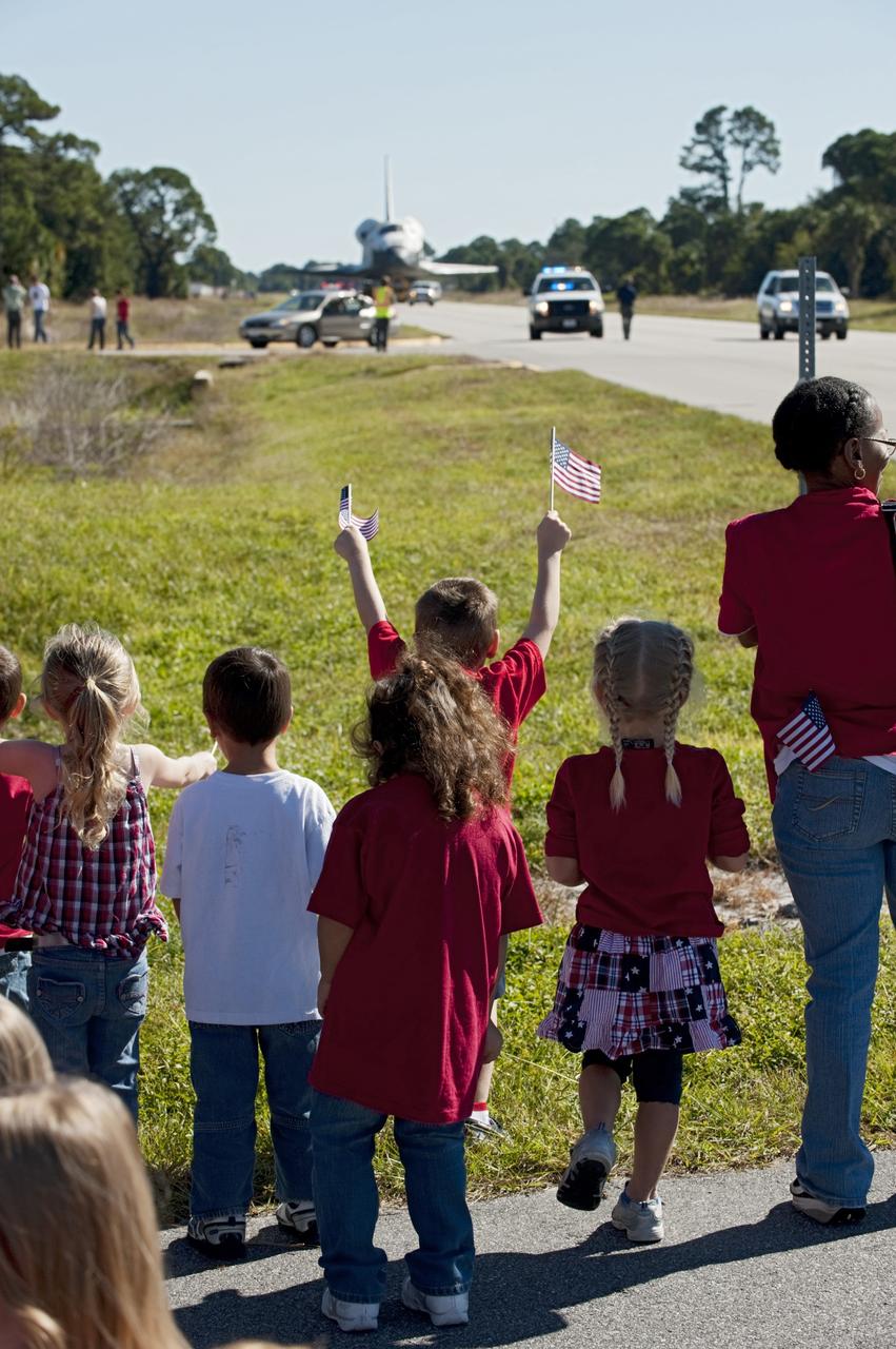 CAPE CANAVERAL, Fla. – Flag waving children welcome the space shuttle Atlantis as it approaches Space Florida's Exploration Park. Atlantis will pause during its 10-mile journey to the Kennedy Space Center Visitor Complex providing a viewing opportunity for guests before completing the trip to its new home. As part of transition and retirement of the Space Shuttle Program, Atlantis is to be displayed at Kennedy's Visitor Complex beginning in the summer of 2013. Over the course of its 26-year career, Atlantis traveled 125,935,769 miles during 307 days in space over 33 missions. For more information, visit http://www.nasa.gov/transition Photo credit: NASA/ Tony Gray