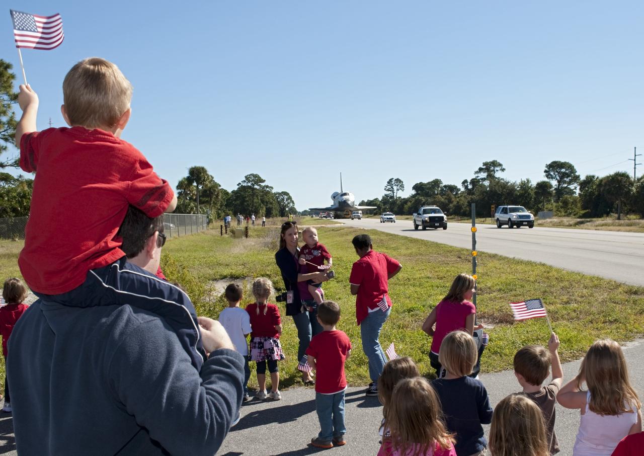 CAPE CANAVERAL, Fla. – Flag waving children welcome the space shuttle Atlantis as it approaches Space Florida's Exploration Park. Atlantis will pause during its 10-mile journey to the Kennedy Space Center Visitor Complex providing a viewing opportunity for guests before completing the trip to its new home. As part of transition and retirement of the Space Shuttle Program, Atlantis is to be displayed at Kennedy's Visitor Complex beginning in the summer of 2013. Over the course of its 26-year career, Atlantis traveled 125,935,769 miles during 307 days in space over 33 missions. For more information, visit http://www.nasa.gov/transition Photo credit: NASA/ Tony Gray