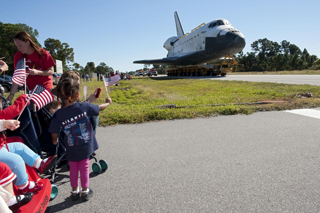 CAPE CANAVERAL, Fla. – Flag waving children welcome the space shuttle Atlantis as it approaches Space Florida's Exploration Park. Atlantis will pause during its 10-mile journey to the Kennedy Space Center Visitor Complex providing a viewing opportunity for guests before completing the trip to its new home. As part of transition and retirement of the Space Shuttle Program, Atlantis is to be displayed at Kennedy's Visitor Complex beginning in the summer of 2013. Over the course of its 26-year career, Atlantis traveled 125,935,769 miles during 307 days in space over 33 missions. For more information, visit http://www.nasa.gov/transition Photo credit: NASA/ Tony Gray