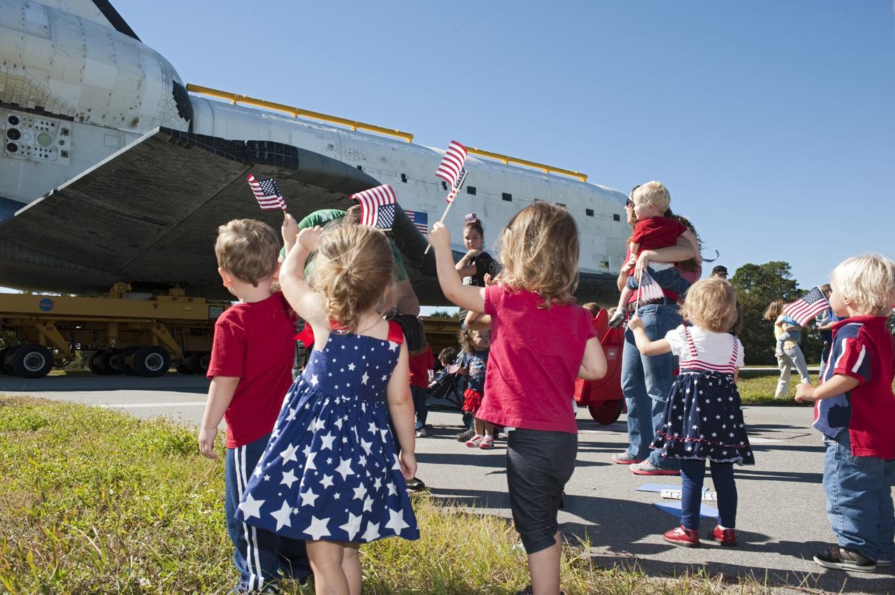 CAPE CANAVERAL, Fla. – Flag waving children welcome the space shuttle Atlantis as it approaches Space Florida's Exploration Park. Atlantis will pause during its 10-mile journey to the Kennedy Space Center Visitor Complex providing a viewing opportunity for guests before completing the trip to its new home. As part of transition and retirement of the Space Shuttle Program, Atlantis is to be displayed at Kennedy's Visitor Complex beginning in the summer of 2013. Over the course of its 26-year career, Atlantis traveled 125,935,769 miles during 307 days in space over 33 missions. For more information, visit http://www.nasa.gov/transition Photo credit: NASA/ Tony Gray