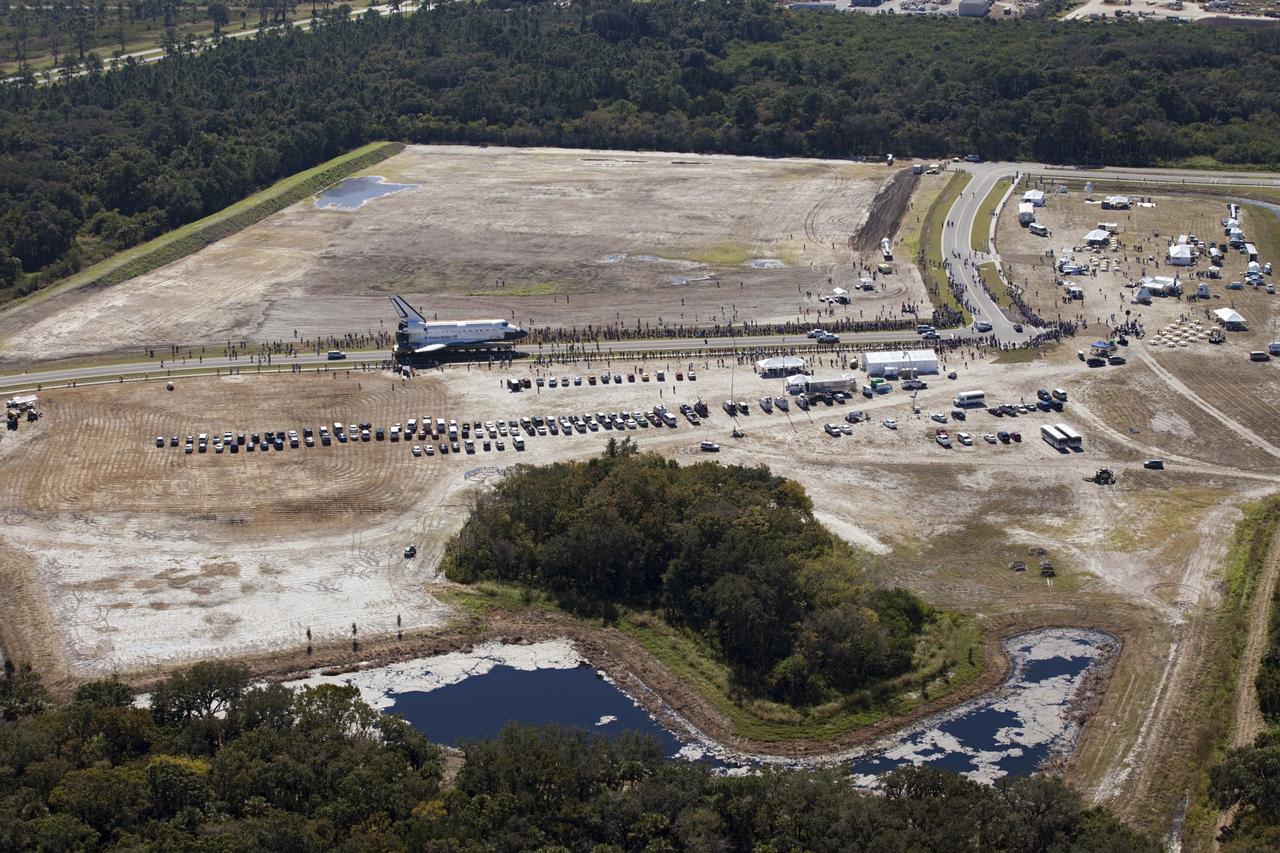 CAPE CANAVERAL, Fla. – At NASA's Kennedy Space Center in Florida, space shuttle Atlantis travels through Space Florida's Exploration Park during its 10-mile journey from the Vehicle Assembly Building to the Kennedy Space Center Visitor Complex. Atlantis will stop in the park for a viewing opportunity for visitor complex guests before completing the trip to its new home. As part of transition and retirement of the Space Shuttle Program, Atlantis will be displayed in a new exhibit hall at the visitor complex beginning in the summer of 2013. Over the course of its 26-year career, Atlantis traveled 125,935,769 miles, completing 33 missions during 307 days in space. For more information, visit http://www.nasa.gov/transition. Photo credit: NASA/Kim Shiflett