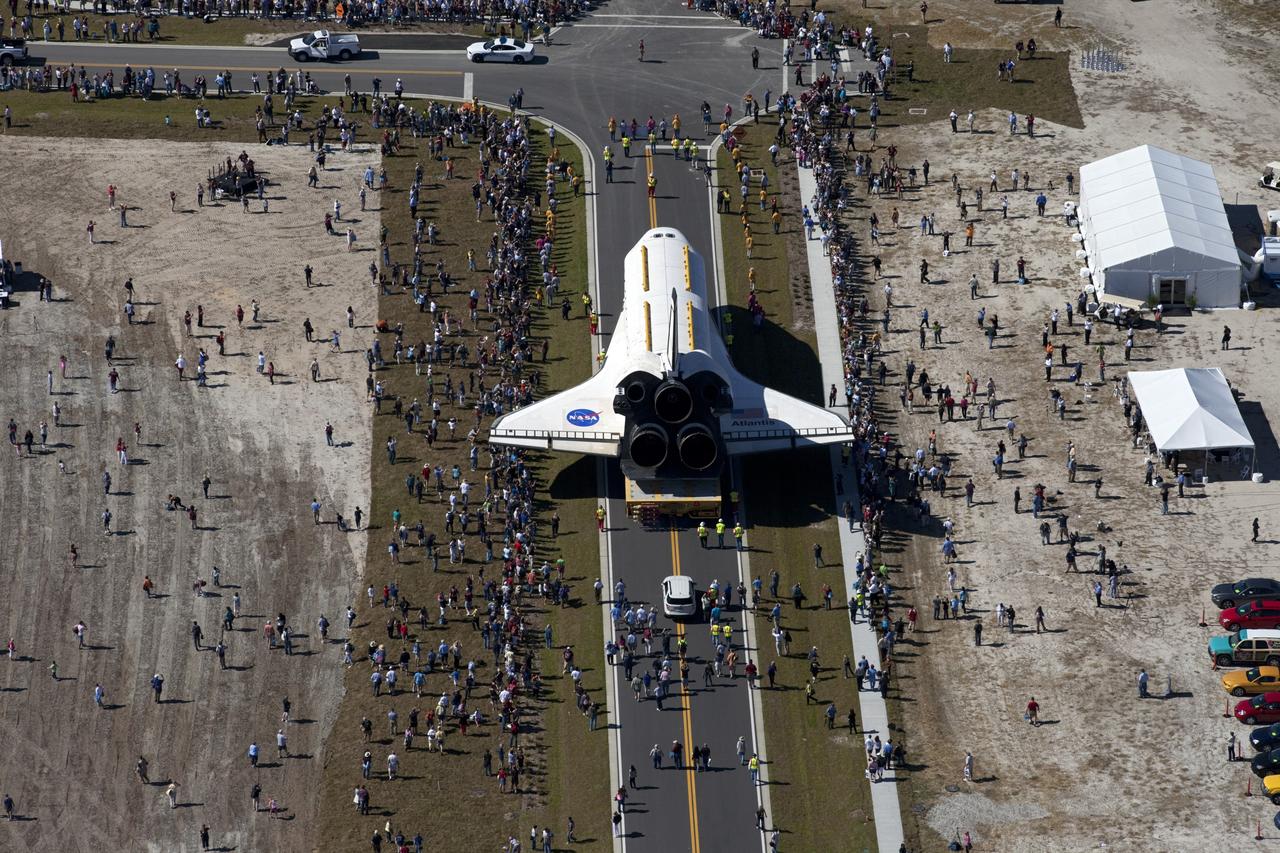 CAPE CANAVERAL, Fla. – At NASA's Kennedy Space Center in Florida, a crowd gathers around space shuttle Atlantis as it travels through Space Florida's Exploration Park during its 10-mile journey from the Vehicle Assembly Building to the Kennedy Space Center Visitor Complex. Atlantis will stop in the park for a viewing opportunity for visitor complex guests before completing the trip to its new home. As part of transition and retirement of the Space Shuttle Program, Atlantis will be displayed in a new exhibit hall at the visitor complex beginning in the summer of 2013. Over the course of its 26-year career, Atlantis traveled 125,935,769 miles, completing 33 missions during 307 days in space. For more information, visit http://www.nasa.gov/transition. Photo credit: NASA/Kim Shiflett