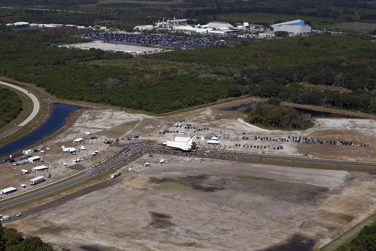 CAPE CANAVERAL, Fla. – At NASA's Kennedy Space Center in Florida, space shuttle Atlantis moves through Space Florida's Exploration Park during its 10-mile journey from the Vehicle Assembly Building to the Kennedy Space Center Visitor Complex. Atlantis will stop in the park for a viewing opportunity for visitor complex guests before completing the trip to its new home. As part of transition and retirement of the Space Shuttle Program, Atlantis will be displayed in a new exhibit hall at the visitor complex beginning in the summer of 2013. Over the course of its 26-year career, Atlantis traveled 125,935,769 miles, completing 33 missions during 307 days in space. For more information, visit http://www.nasa.gov/transition. Photo credit: NASA/Kim Shiflett