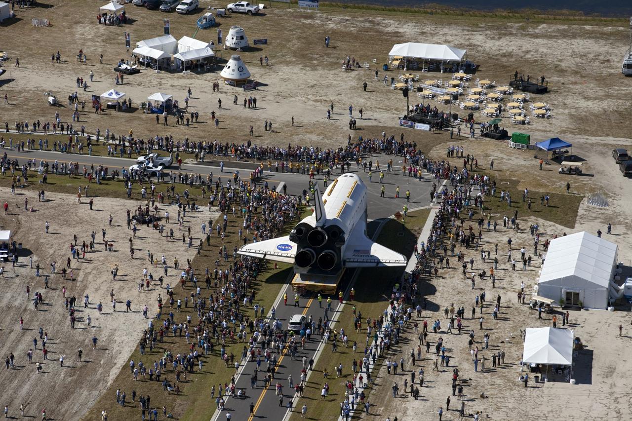 CAPE CANAVERAL, Fla. – At NASA's Kennedy Space Center in Florida, a crowd gathers around space shuttle Atlantis as it moves through Space Florida's Exploration Park during its 10-mile journey from the Vehicle Assembly Building to the Kennedy Space Center Visitor Complex. Atlantis will stop in the park for a viewing opportunity for visitor complex guests before completing the trip to its new home.     As part of transition and retirement of the Space Shuttle Program, Atlantis will be displayed in a new exhibit hall at the visitor complex beginning in the summer of 2013. Over the course of its 26-year career, Atlantis traveled 125,935,769 miles, completing 33 missions during 307 days in space. For more information, visit http://www.nasa.gov/transition.  Photo credit: NASA/Kim Shiflett