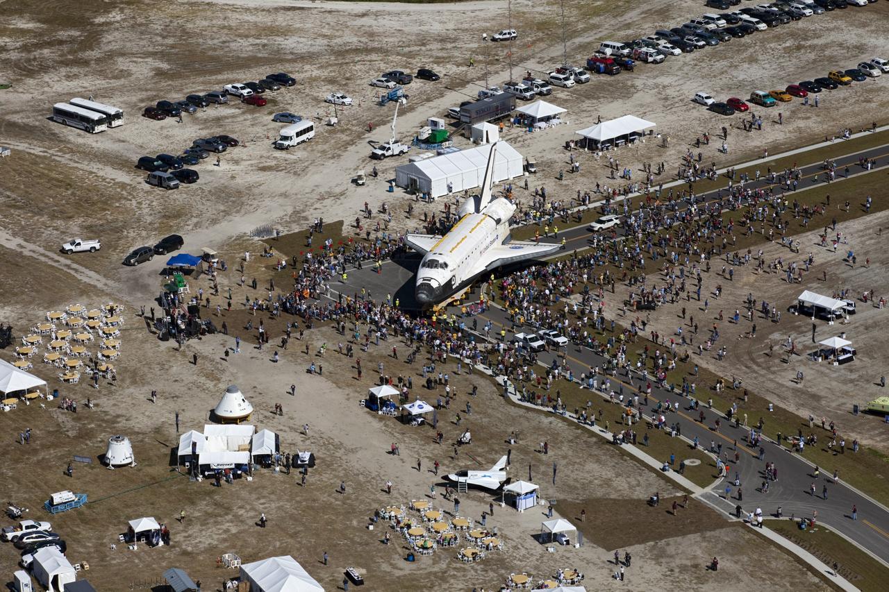 CAPE CANAVERAL, Fla. – At NASA's Kennedy Space Center in Florida, a crowd gathers around space shuttle Atlantis in Space Florida's Exploration Park during its 10-mile journey from the Vehicle Assembly Building to the Kennedy Space Center Visitor Complex. Atlantis stopped in the park for a viewing opportunity for visitor complex guests before completing the trip to its new home.     As part of transition and retirement of the Space Shuttle Program, Atlantis will be displayed in a new exhibit hall at the visitor complex beginning in the summer of 2013. Over the course of its 26-year career, Atlantis traveled 125,935,769 miles, completing 33 missions during 307 days in space. For more information, visit http://www.nasa.gov/transition.  Photo credit: NASA/Kim Shiflett