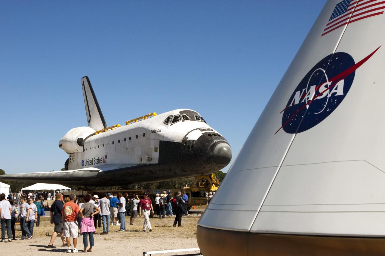 CAPE CANAVERAL, Fla. – The space shuttle Atlantis arrives at Space Florida's Exploration Park where it will pause during its 10-mile journey to the Kennedy Space Center Visitor Complex. The stop will provide a viewing opportunity for guests before completing the trip to its new home. In the foreground to the right is a future spacecraft that could take astronauts to space. As part of transition and retirement of the Space Shuttle Program, Atlantis is to be displayed at Kennedy's visitor complex beginning in the summer of 2013. Over the course of its 26-year career, Atlantis traveled 125,935,769 miles during 307 days in space over 33 missions. For more information, visit http://www.nasa.gov/transition. Photo credit: NASA/Jim Grossmann