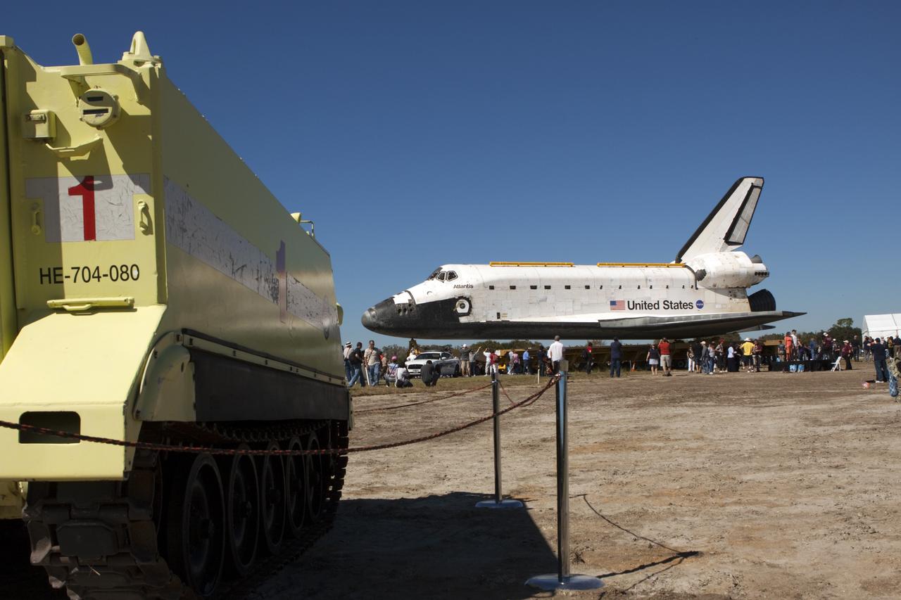 CAPE CANAVERAL, Fla. – The space shuttle Atlantis is viewed by guests at Space Florida's Exploration Park where it paused during its 10-mile journey to the Kennedy Space Center Visitor Complex. The stop will provide a viewing opportunity before completing the trip to its new home. In the foreground to the left is an M-113 armored personnel carrier that was one of several exhibits available for visitors. As part of transition and retirement of the Space Shuttle Program, Atlantis is to be displayed at Kennedy's visitor complex beginning in the summer of 2013. Over the course of its 26-year career, Atlantis traveled 125,935,769 miles during 307 days in space over 33 missions. For more information, visit http://www.nasa.gov/transition. Photo credit: NASA/Jim Grossmann