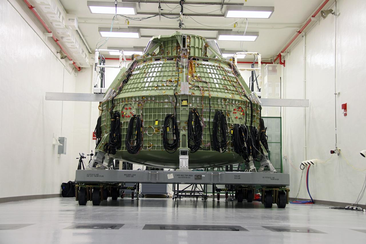 CAPE CANAVERAL, Fla. – The Orion Exploration Flight Test 1 crew module is undergoing proof pressure testing at the Operations and Checkout Building at NASA's Kennedy Space Center in Florida. The test incrementally pressurizes the spacecraft with breathing air and is designed to demonstrate weld strength capability and structural performance at maximum flight operating pressures.      Orion is the exploration spacecraft designed to carry crews to space beyond low Earth orbit. It will provide emergency abort capability, sustain the crew during the space travel and provide safe re-entry from deep space return velocities. The first unpiloted test flight of the Orion is scheduled to launch in 2014 atop a Delta IV rocket and in 2017 on a Space Launch System rocket. For more information, visit http://www.nasa.gov/orion Photo credit: NASA/Ben Smegelsky