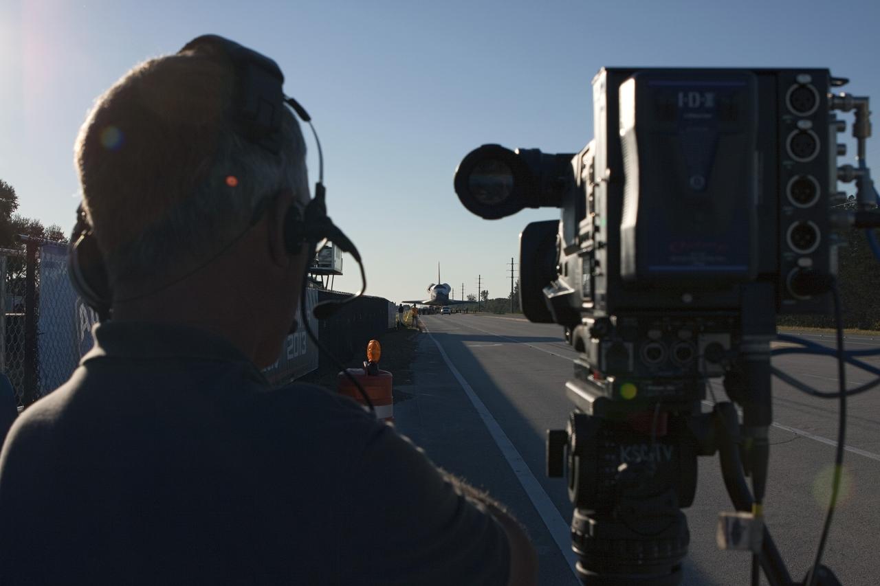 CAPE CANAVERAL, Fla. – Film crews and photographers wait as space shuttle Atlantis is transported along the NASA Causeway on its 10-mile journey from NASA Kennedy Space Center’s Vehicle Assembly Building in Florida to the Kennedy Visitor Complex where it will be put on public display. As part of transition and retirement of the Space Shuttle Program, Atlantis will be displayed at Kennedy’s Visitor Complex beginning in the summer of 2013. Over the course of its 26-year career, Atlantis traveled 125,935,769 miles during 307 days in space over 33 missions. For more information, visit http://www.nasa.gov/transition. Photo credit: NASA/Jim Grossmann