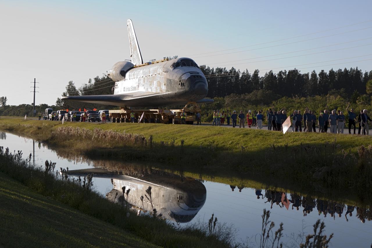 CAPE CANAVERAL, Fla. – Kennedy Space Center workers and members of the media watch as space shuttle Atlantis is transported along the NASA Causeway on its 10-mile journey from NASA Kennedy Space Center’s Vehicle Assembly Building in Florida to the Kennedy Visitor Complex where it will be put on public display. As part of transition and retirement of the Space Shuttle Program, Atlantis will be displayed at Kennedy’s Visitor Complex beginning in the summer of 2013. Over the course of its 26-year career, Atlantis traveled 125,935,769 miles during 307 days in space over 33 missions. For more information, visit http://www.nasa.gov/transition. Photo credit: NASA/Jim Grossmann