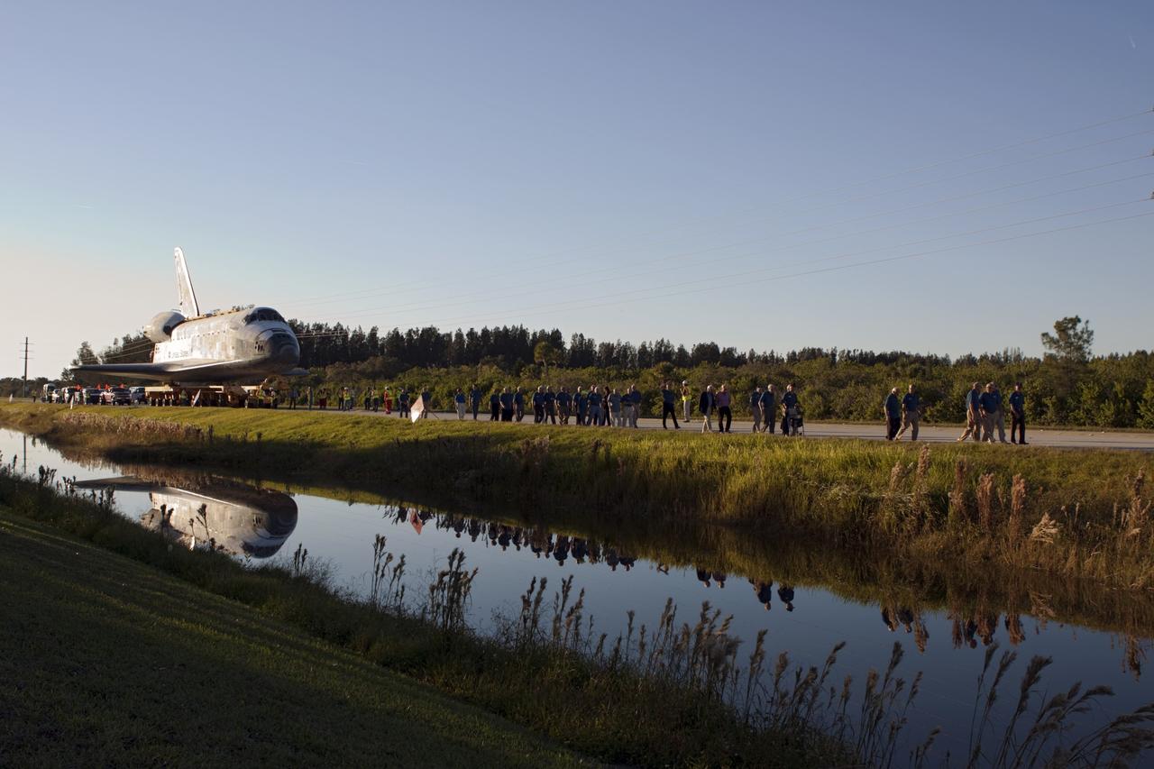 CAPE CANAVERAL, Fla. – Kennedy Space Center workers and members of the media watch as space shuttle Atlantis is transported along the NASA Causeway on its 10-mile journey from NASA Kennedy Space Center’s Vehicle Assembly Building in Florida to the Kennedy Visitor Complex where it will be put on public display. As part of transition and retirement of the Space Shuttle Program, Atlantis will be displayed at Kennedy’s Visitor Complex beginning in the summer of 2013. Over the course of its 26-year career, Atlantis traveled 125,935,769 miles during 307 days in space over 33 missions. For more information, visit http://www.nasa.gov/transition. Photo credit: NASA/Jim Grossmann