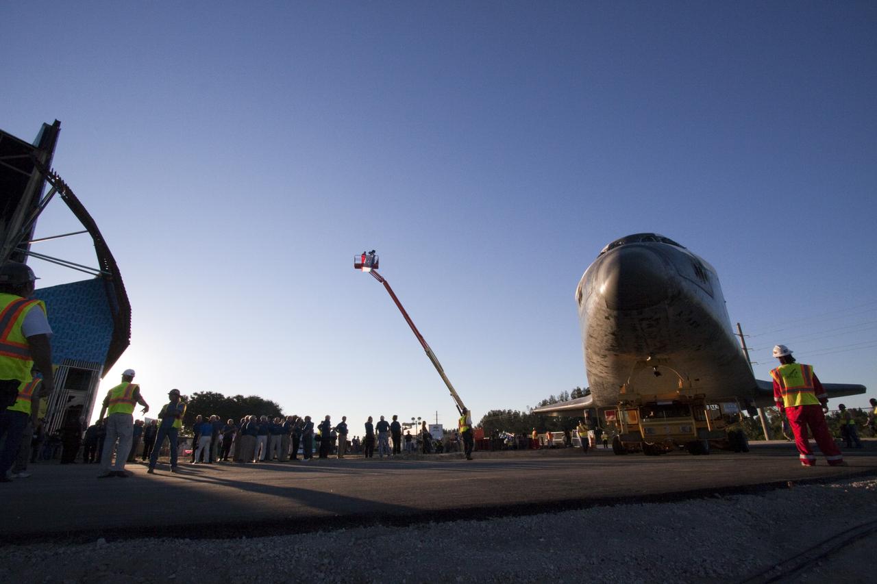 CAPE CANAVERAL, Fla. – Kennedy Space Center workers and members of the media watch as space shuttle Atlantis arrives at the Kennedy Space Center Visitor Complex in Florida where it will be put on public display. Atlantis completed its 10-mile journey from Kennedy’s Vehicle Assembly Building. As part of transition and retirement of the Space Shuttle Program, Atlantis will be displayed at Kennedy’s Visitor Complex beginning in the summer of 2013. Over the course of its 26-year career, Atlantis traveled 125,935,769 miles during 307 days in space over 33 missions. For more information, visit http://www.nasa.gov/transition. Photo credit: NASA/Jim Grossmann