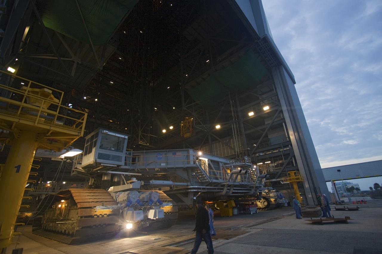 CAPE CANAVERAL, Fla. -- At NASA's Kennedy Space Center in Florida, crawler-transporter No. 2 moves out of high bay 2 of the Vehicle Assembly Building where it has been undergoing modifications. The test drive is designed to check out modifications to ensure its ability to carry launch vehicles such as the space agency's Space Launch System heavy-lift rocket to the launch pad. NASA's Ground Systems Development and Operations Program is leading the 20-year life-extension project for the crawler. A pair of behemoth machines called crawler-transporters has carried the load of taking rockets and spacecraft to the launch pad for more than 40 years at NASA’s Kennedy Space Center in Florida. Each the size of a baseball infield and powered by locomotive and large electrical power generator engines, the crawler-transporters will stand ready to keep up the work for the next generation of launch vehicles projects to lift astronauts into space. For more information, visit http://www.nasa.gov/exploration/systems/ground/index.html Photo credit: NASA/Jim Grossmann