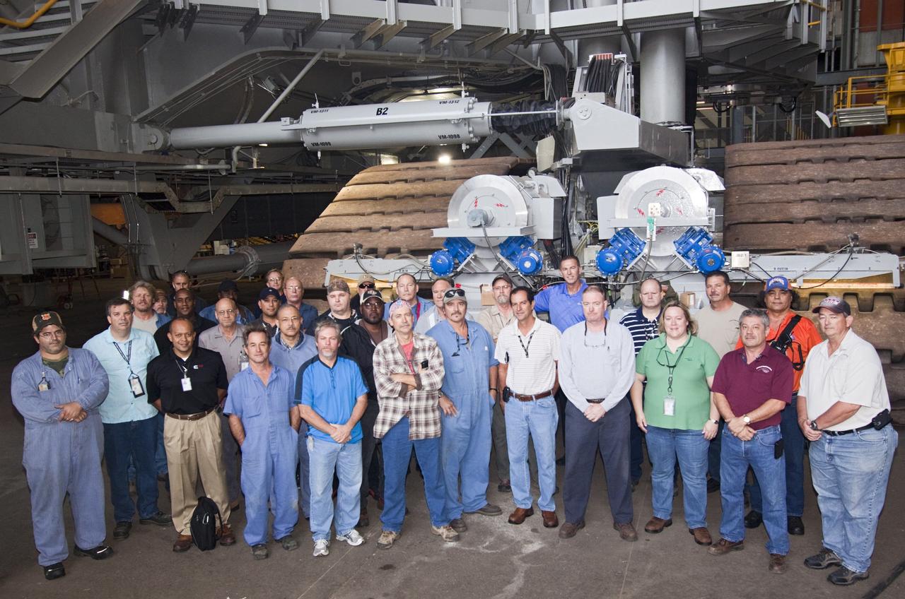 CAPE CANAVERAL, Fla. -- The team that has been modifying crawler-transporter No. 2 inside high bay 2 of the Vehicle Assembly Building at NASA's Kennedy Space Center in Florida gathered prior to a test drive. The crawler-transporter has been undergoing modifications in preparation to carry launch vehicles such as the space agency's Space Launch System heavy-lift rocket to the launch pad. NASA's Ground Systems Development and Operations Program is leading the 20-year life-extension project for the crawler. A pair of behemoth machines called crawler-transporters has carried the load of taking rockets and spacecraft to the launch pad for more than 40 years at NASA’s Kennedy Space Center in Florida. Each the size of a baseball infield and powered by locomotive and large electrical power generator engines, the crawler-transporters will stand ready to keep up the work for the next generation of launch vehicles projects to lift astronauts into space. For more information, visit http://www.nasa.gov/exploration/systems/ground/index.html Photo credit: NASA/Jim Grossmann
