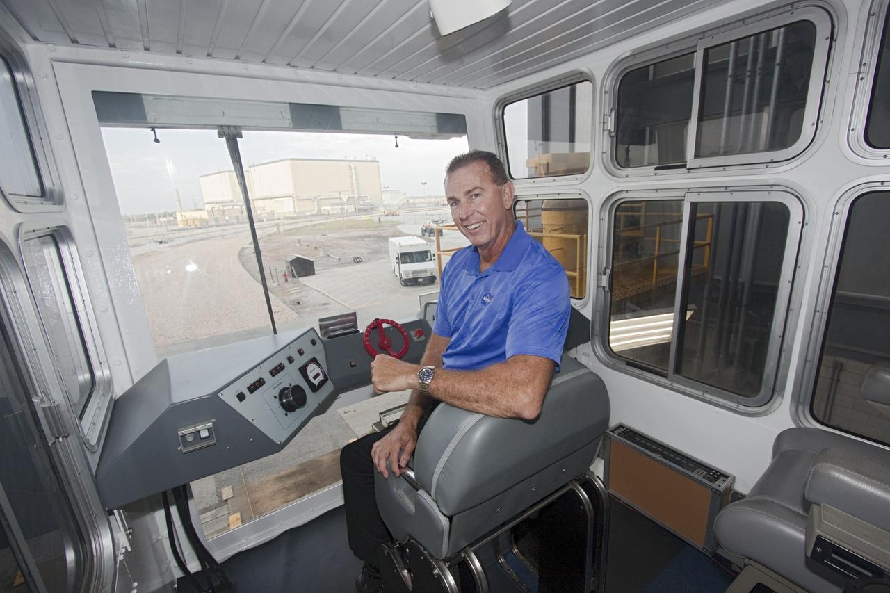 CAPE CANAVERAL, Fla. -- United Space Alliance Project Manager Mike Parrish sits in the driver's position of crawler-transporter No. 2 which has been undergoing modifications inside high bay 2 of the Vehicle Assembly Building at NASA's Kennedy Space Center in Florida. The upgrades are designed to ensure the crawler-transporter can carry launch vehicles such as the space agency's Space Launch System heavy-lift rocket to the launch pad. NASA's Ground Systems Development and Operations Program is leading the 20-year life-extension project for the crawler. A pair of behemoth machines called crawler-transporters has carried the load of taking rockets and spacecraft to the launch pad for more than 40 years at NASA’s Kennedy Space Center in Florida. Each the size of a baseball infield and powered by locomotive and large electrical power generator engines, the crawler-transporters will stand ready to keep up the work for the next generation of launch vehicles projects to lift astronauts into space. For more information, visit http://www.nasa.gov/exploration/systems/ground/index.html Photo credit: NASA/Jim Grossmann