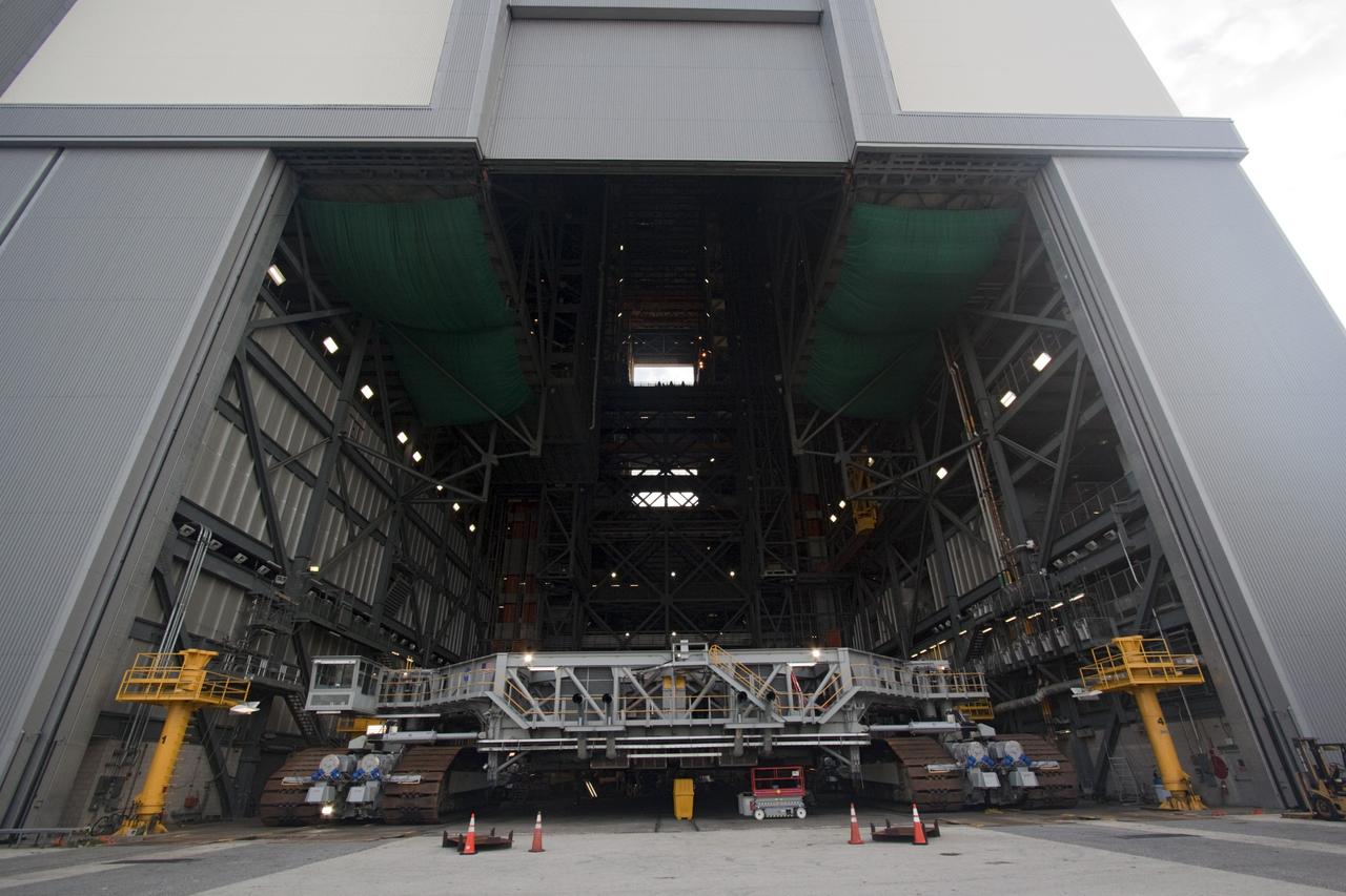 CAPE CANAVERAL, Fla. -- At NASA's Kennedy Space Center in Florida, crawler-transporter No. 2 moves out of high bay 2 of the Vehicle Assembly Building where it has been undergoing modifications. The test drive is designed to check out modifications to ensure its ability to carry launch vehicles such as the space agency's Space Launch System heavy-lift rocket to the launch pad. NASA's Ground Systems Development and Operations Program is leading the 20-year life-extension project for the crawler. A pair of behemoth machines called crawler-transporters has carried the load of taking rockets and spacecraft to the launch pad for more than 40 years at NASA’s Kennedy Space Center in Florida. Each the size of a baseball infield and powered by locomotive and large electrical power generator engines, the crawler-transporters will stand ready to keep up the work for the next generation of launch vehicles projects to lift astronauts into space. For more information, visit http://www.nasa.gov/exploration/systems/ground/index.html Photo credit: NASA/Jim Grossmann