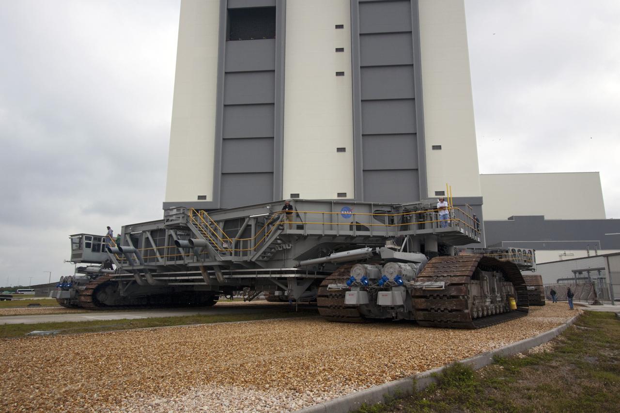 CAPE CANAVERAL, Fla. -- At NASA's Kennedy Space Center in Florida, crawler-transporter No. 2 moves out of high bay 2 of the Vehicle Assembly Building where it has been undergoing modifications. The test drive is designed to check out modifications to ensure its ability to carry launch vehicles such as the space agency's Space Launch System heavy-lift rocket to the launch pad. NASA's Ground Systems Development and Operations Program is leading the 20-year life-extension project for the crawler. A pair of behemoth machines called crawler-transporters has carried the load of taking rockets and spacecraft to the launch pad for more than 40 years at NASA’s Kennedy Space Center in Florida. Each the size of a baseball infield and powered by locomotive and large electrical power generator engines, the crawler-transporters will stand ready to keep up the work for the next generation of launch vehicles projects to lift astronauts into space. For more information, visit http://www.nasa.gov/exploration/systems/ground/index.html Photo credit: NASA/Jim Grossmann