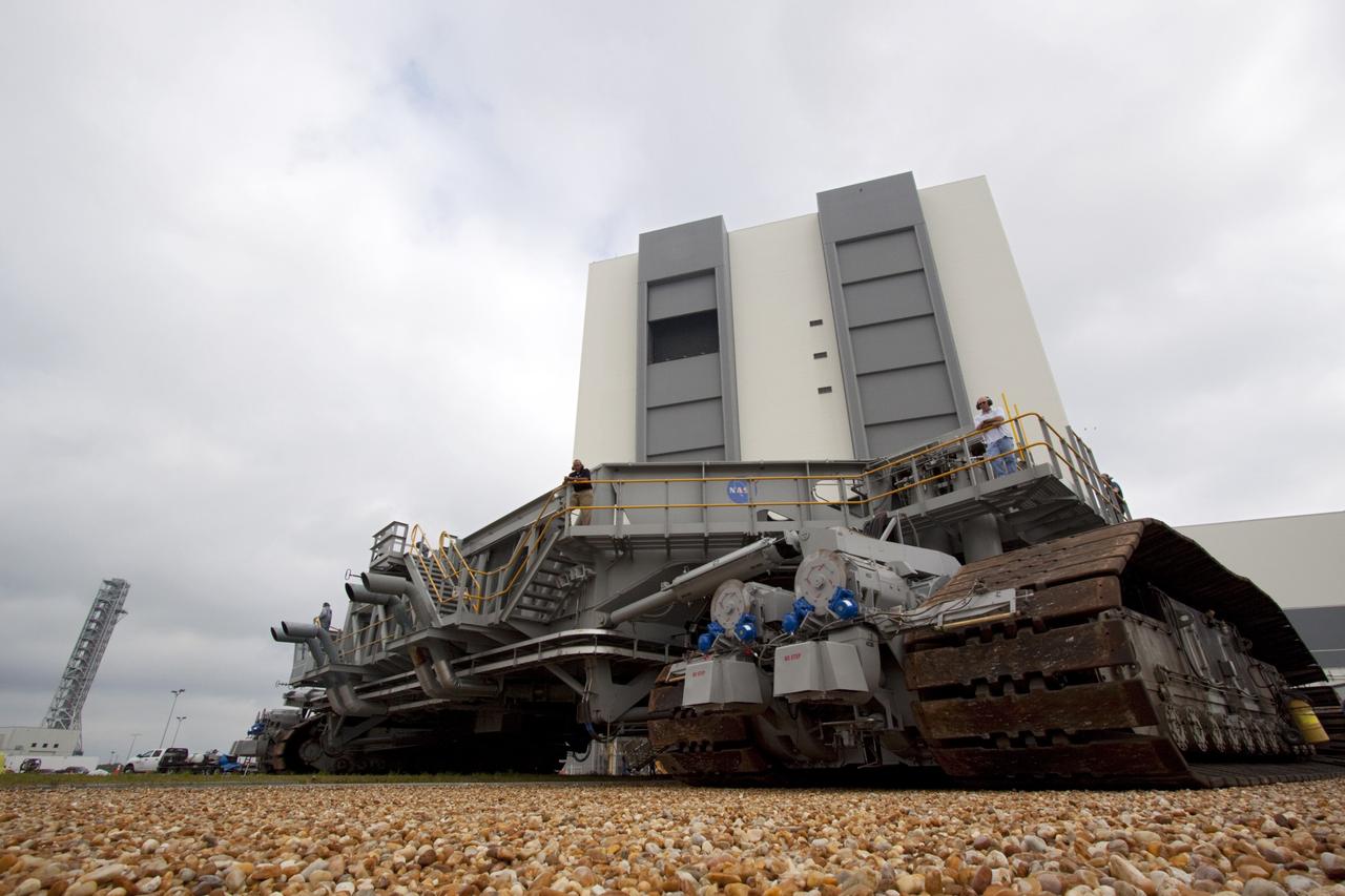 CAPE CANAVERAL, Fla. -- At NASA's Kennedy Space Center in Florida, crawler-transporter No. 2 moves out of high bay 2 of the Vehicle Assembly Building where it has been undergoing modifications. The test dive is designed to check out modifications to ensure its ability to carry the space agency's Space Launch System heavy-lift rocket to the launch pad. NASA's Ground Systems Development and Operations Program is leading the 20-year life-extension project for the crawler. A pair of behemoth machines called crawler-transporters has carried the load of taking rockets and spacecraft to the launch pad for more than 40 years at NASA’s Kennedy Space Center in Florida. Each the size of a baseball infield and powered by locomotive and large electrical power generator engines, the crawler-transporters will stand ready to keep up the work for the next generation of launch vehicles projects to lift astronauts into space. For more information, visit http://www.nasa.gov/exploration/systems/ground/index.html Photo credit: NASA/Jim Grossmann