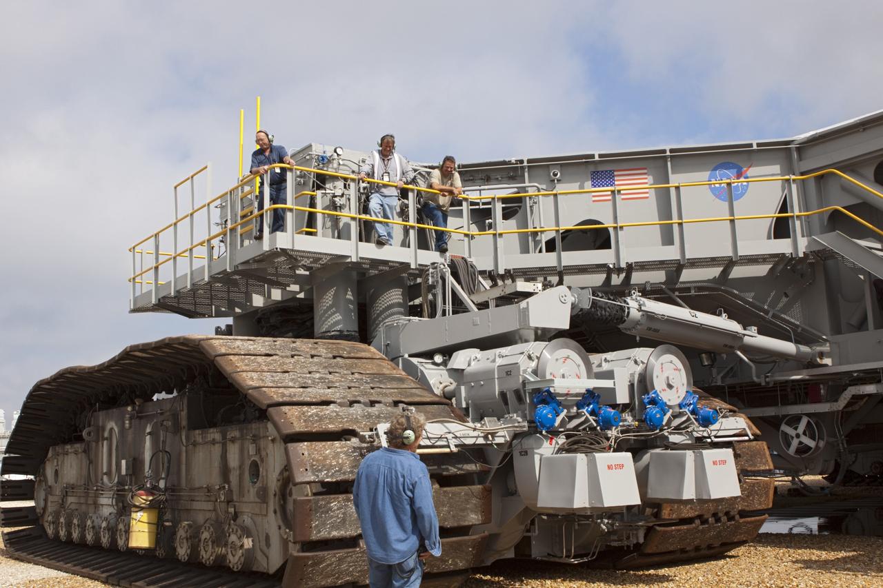 CAPE CANAVERAL, Fla. -- Technicians keep watch as crawler-transporter No. 2 moves along the crawler way at NASA's Kennedy Space Center in Florida. The crawler-transporter test dive is designed to check out recent modifications to ensure its ability to carry the space agency's Space Launch System heavy-lift rocket to the launch pad. NASA's Ground Systems Development and Operations Program is leading the 20-year life-extension project for the crawler. A pair of behemoth machines called crawler-transporters has carried the load of taking rockets and spacecraft to the launch pad for more than 40 years at NASA’s Kennedy Space Center in Florida. Each the size of a baseball infield and powered by locomotive and large electrical power generator engines, the crawler-transporters will stand ready to keep up the work for the next generation of launch vehicles projects to lift astronauts into space. For more information, visit http://www.nasa.gov/exploration/systems/ground/index.html Photo credit: NASA/Jim Grossmann