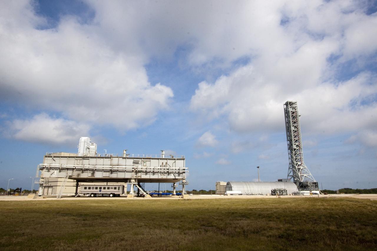 CAPE CANAVERAL, Fla. -- At NASA's Kennedy Space Center in Florida, a space shuttle era mobile launcher platform, on the left, sits on pedestals outside the Vehicle Assembly Building. To the right is the mobile launcher that will support the space agency's Space Launch System heavy-lift rocket and Orion spacecraft. NASA's Ground Systems Development and Operations Program is leading the 20-year life-extension project for the crawler. A pair of behemoth machines called crawler-transporters has carried the load of taking rockets and spacecraft to the launch pad for more than 40 years at NASA’s Kennedy Space Center in Florida. Each the size of a baseball infield and powered by locomotive and large electrical power generator engines, the crawler-transporters will stand ready to keep up the work for the next generation of launch vehicles projects to lift astronauts into space. For more information, visit http://www.nasa.gov/exploration/systems/ground/index.html Photo credit: NASA/Jim Grossmann
