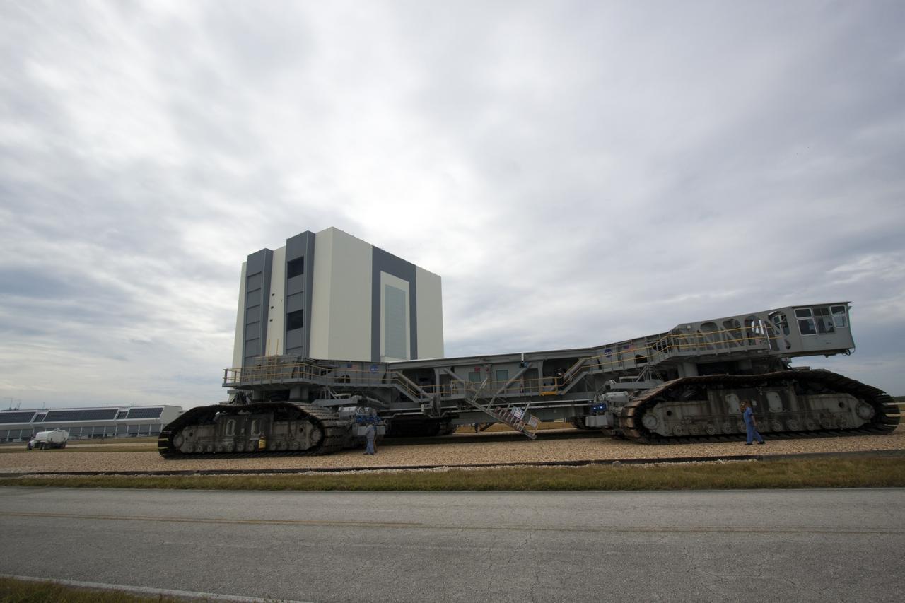 CAPE CANAVERAL, Fla. -- At NASA's Kennedy Space Center in Florida, crawler-transporter No. 2 moves past the Vehicle Assembly Building where it has been undergoing modifications. The test drive is designed to check out modifications to ensure its ability to carry launch vehicles such as the space agency's Space Launch System heavy-lift rocket to the launch pad. NASA's Ground Systems Development and Operations Program is leading the 20-year life-extension project for the crawler. A pair of behemoth machines called crawler-transporters has carried the load of taking rockets and spacecraft to the launch pad for more than 40 years at NASA’s Kennedy Space Center in Florida. Each the size of a baseball infield and powered by locomotive and large electrical power generator engines, the crawler-transporters will stand ready to keep up the work for the next generation of launch vehicles projects to lift astronauts into space. For more information, visit http://www.nasa.gov/exploration/systems/ground/index.html Photo credit: NASA/Jim Grossmann