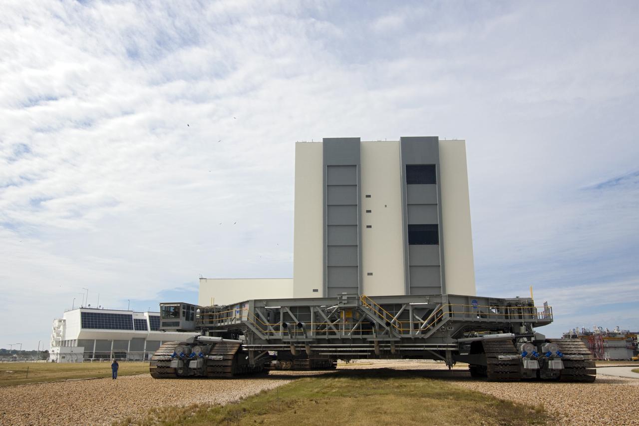 CAPE CANAVERAL, Fla. -- At NASA's Kennedy Space Center in Florida, crawler-transporter No. 2 moves away from the Vehicle Assembly Building where it has been undergoing modifications. The test dive is designed to check out modifications to ensure its ability to carry the space agency's Space Launch System heavy-lift rocket to the launch pad. NASA's Ground Systems Development and Operations Program is leading the 20-year life-extension project for the crawler. A pair of behemoth machines called crawler-transporters has carried the load of taking rockets and spacecraft to the launch pad for more than 40 years at NASA’s Kennedy Space Center in Florida. Each the size of a baseball infield and powered by locomotive and large electrical power generator engines, the crawler-transporters will stand ready to keep up the work for the next generation of launch vehicles projects to lift astronauts into space. For more information, visit http://www.nasa.gov/exploration/systems/ground/index.html Photo credit: NASA/Jim Grossmann