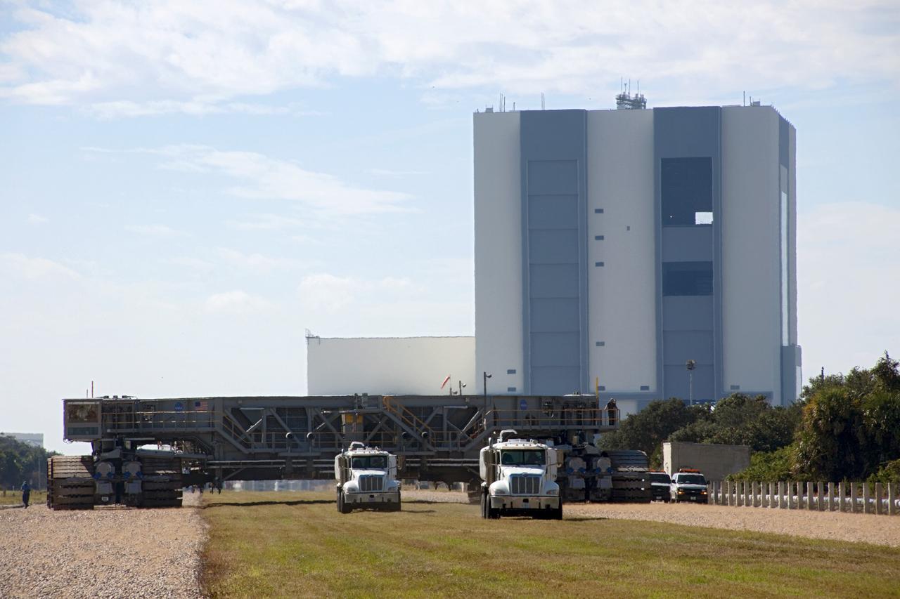 CAPE CANAVERAL, Fla. -- At NASA's Kennedy Space Center in Florida, crawler-transporter No. 2 moves away from the Vehicle Assembly Building where it has been undergoing modifications. The test drive is designed to check out modifications to ensure its ability to carry launch vehicles such as the space agency's Space Launch System heavy-lift rocket to the launch pad. NASA's Ground Systems Development and Operations Program is leading the 20-year life-extension project for the crawler. A pair of behemoth machines called crawler-transporters has carried the load of taking rockets and spacecraft to the launch pad for more than 40 years at NASA’s Kennedy Space Center in Florida. Each the size of a baseball infield and powered by locomotive and large electrical power generator engines, the crawler-transporters will stand ready to keep up the work for the next generation of launch vehicles projects to lift astronauts into space. For more information, visit http://www.nasa.gov/exploration/systems/ground/index.html Photo credit: NASA/Jim Grossmann