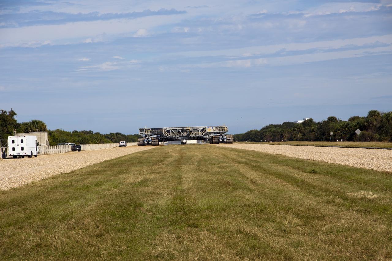 CAPE CANAVERAL, Fla. -- At NASA's Kennedy Space Center in Florida, crawler-transporter No. 2 moves along the crawler way toward Launch Pad 39A following modifications to ensure its ability to carry launch vehicles such as the space agency's Space Launch System heavy-lift rocket to the launch pad. NASA's Ground Systems Development and Operations Program is leading the 20-year life-extension project for the crawler. A pair of behemoth machines called crawler-transporters has carried the load of taking rockets and spacecraft to the launch pad for more than 40 years at NASA’s Kennedy Space Center in Florida. Each the size of a baseball infield and powered by locomotive and large electrical power generator engines, the crawler-transporters will stand ready to keep up the work for the next generation of launch vehicles projects to lift astronauts into space. For more information, visit http://www.nasa.gov/exploration/systems/ground/index.html Photo credit: NASA/Jim Grossmann