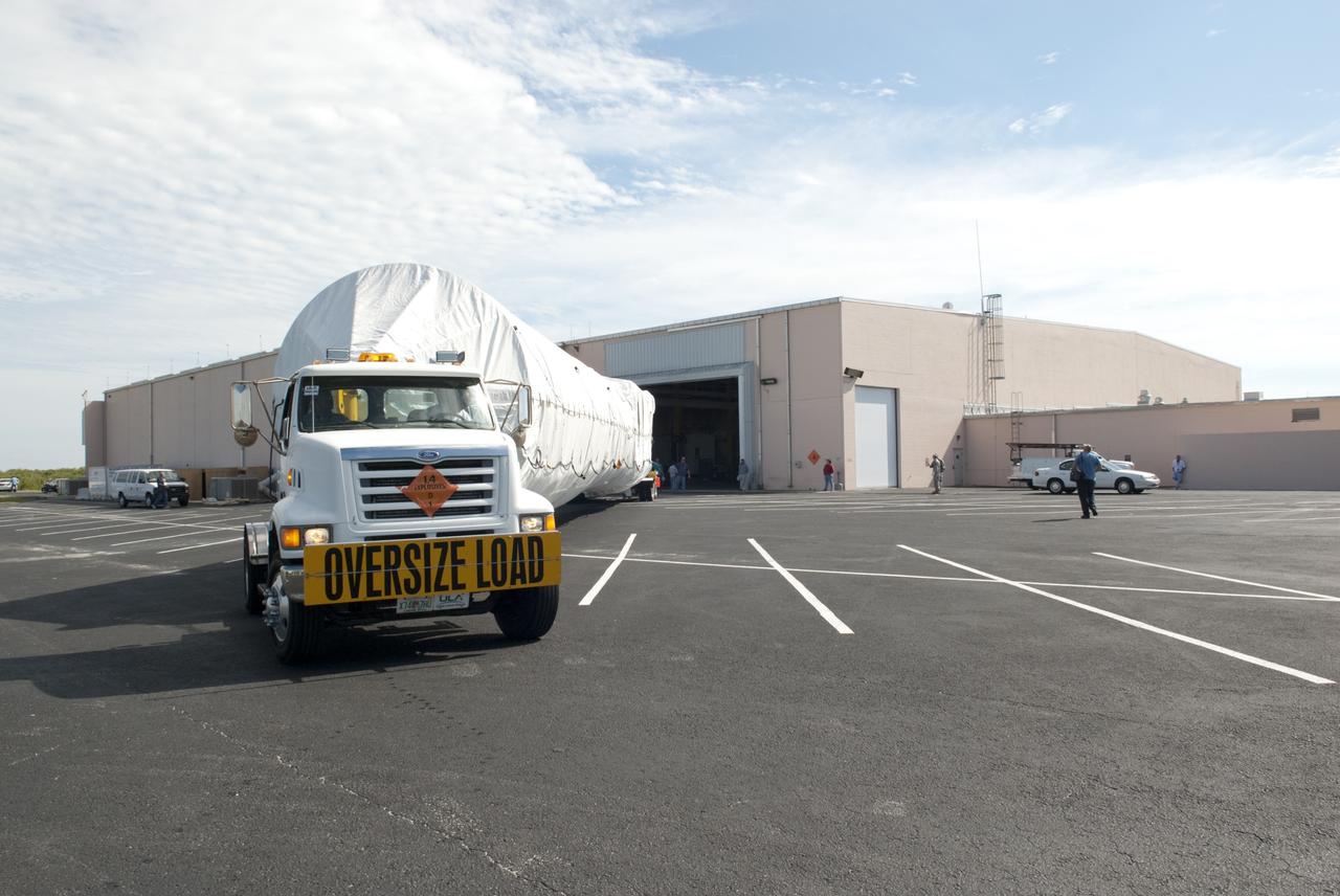 CAPE CANAVERAL, Fla. -- The first stage of the Atlas V rocket that will carry the Tracking and Data Relay Satellite, TDRS-K, into orbit arrives at the hangar at the Atlas Spaceflight Operations Center at Cape Canaveral Air Force Station in Florida to begin processing.      Launch of the TDRS-K on the Atlas V rocket is planned for January 2013 from Space Launch Complex 41. The TDRS-K spacecraft is part of the next-generation series in the Tracking and Data Relay Satellite System, a constellation of space-based communication satellites providing tracking, telemetry, command and high-bandwidth data return services. For more information, visit http://tdrs.gsfc.nasa.gov/ Photo credit: NASA/Charisse Nahser